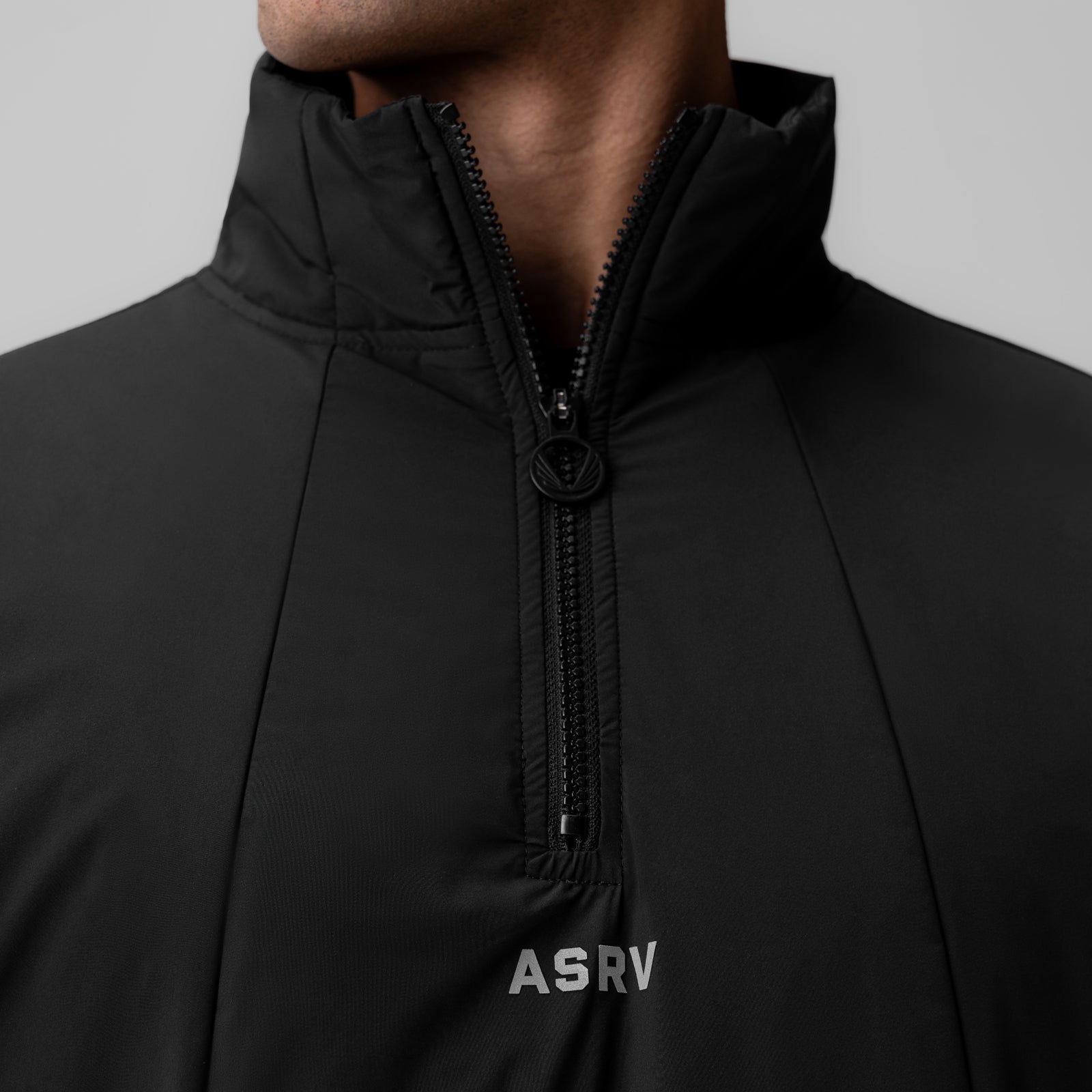 Aerotex PrimaLoft quarter zip jacket in black, worn by model, front detail view