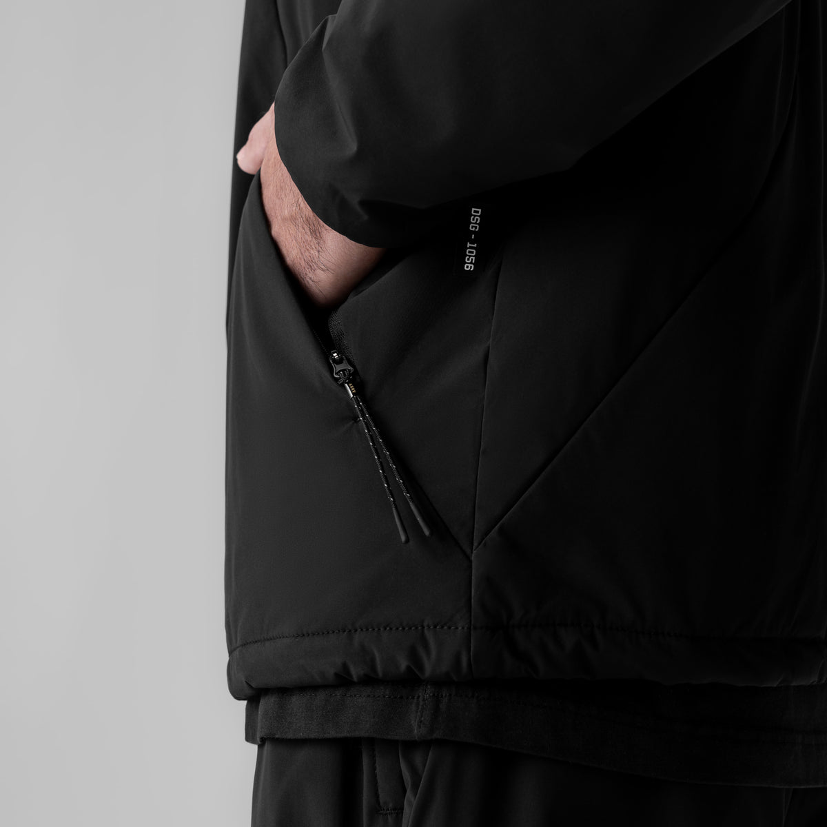 Aerotex PrimaLoft Quarter Zip in black, model wearing jacket with hand in pocket