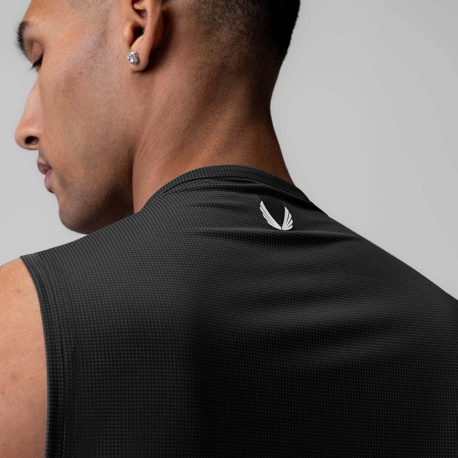 Ice-Skin™ Muscle Tank in black, worn by model shown from side profile view