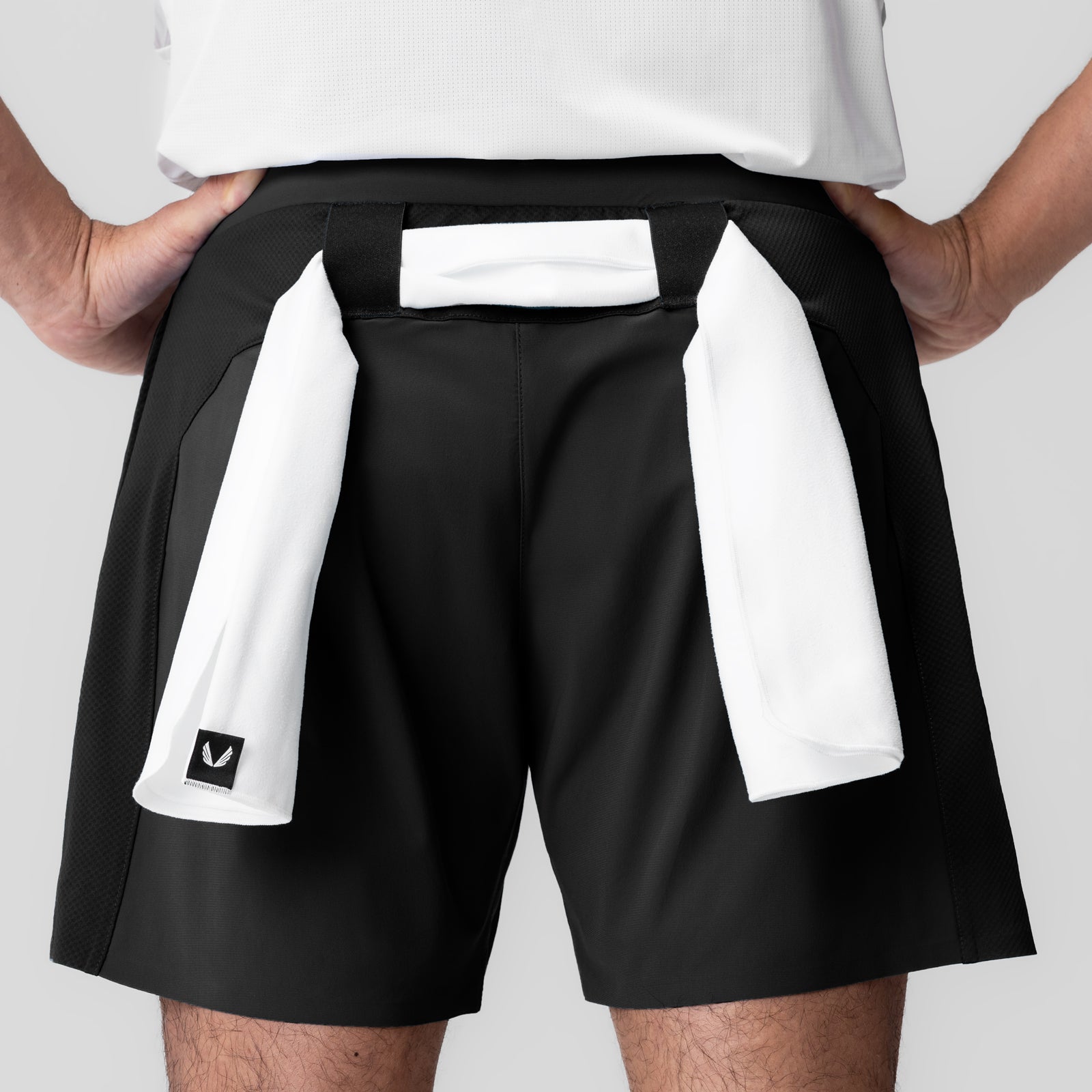 Tetra-Lite Bonded Training Short in black, worn by model with white towel, front view