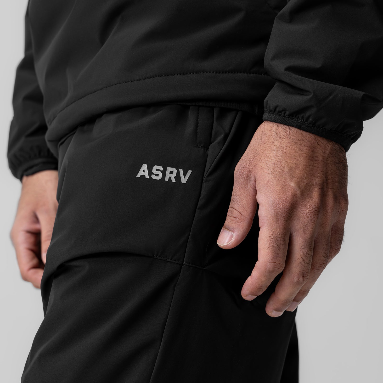 Aerotex™ PrimaLoft® Warm-Up Pant in black, worn by model showing side pocket detail