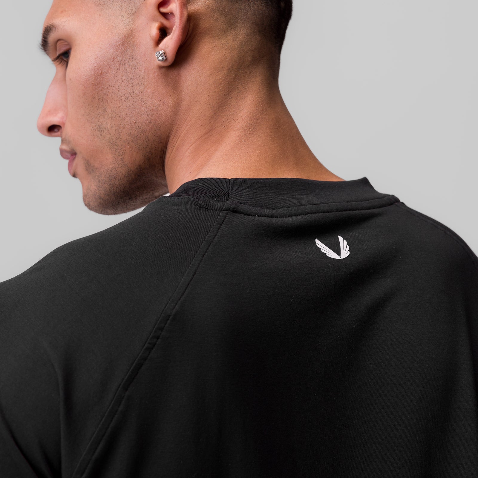 Black Supima® 3/4-sleeve oversized tee worn by model, back view