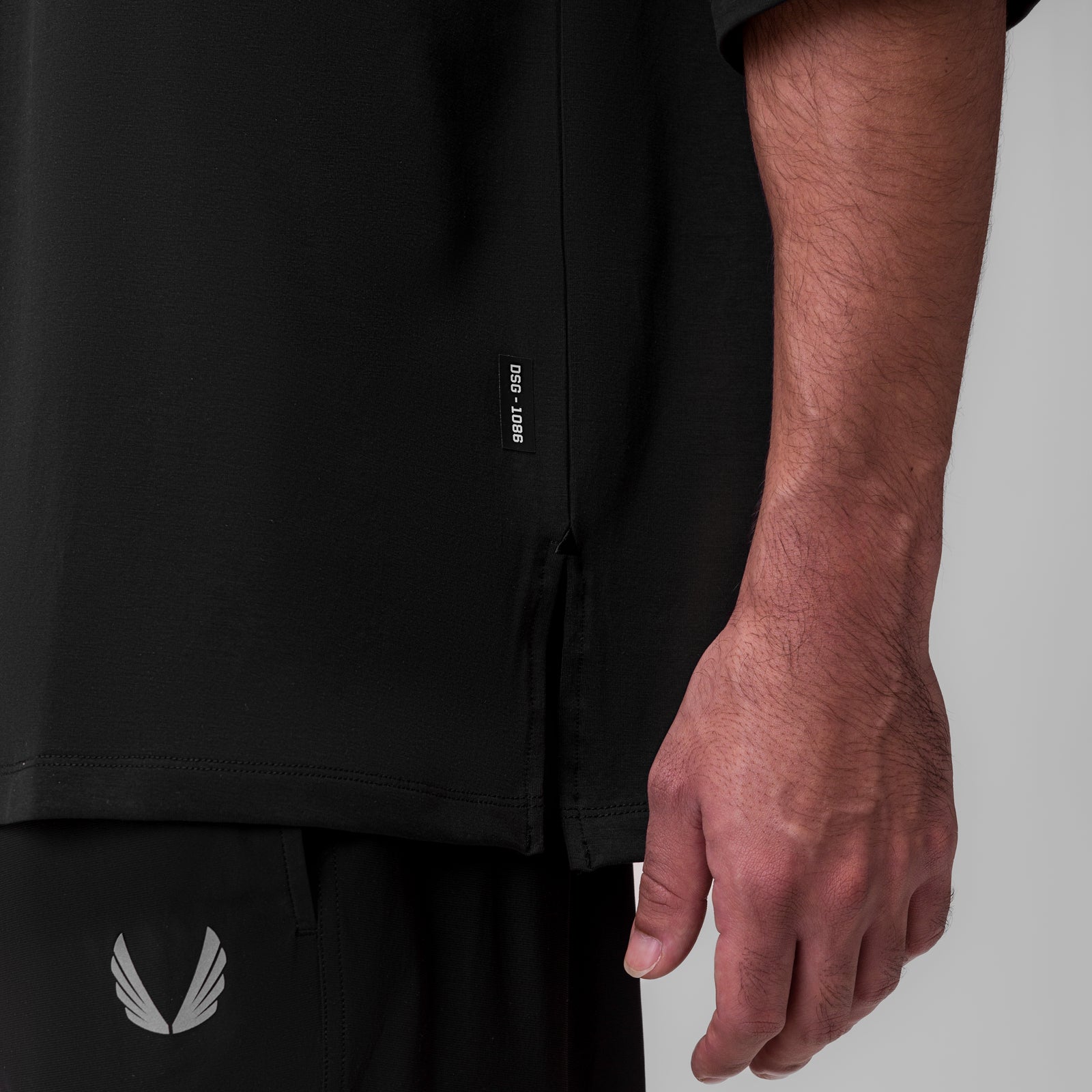 Black Supima 3/4-sleeve oversized tee worn by model, side detail view