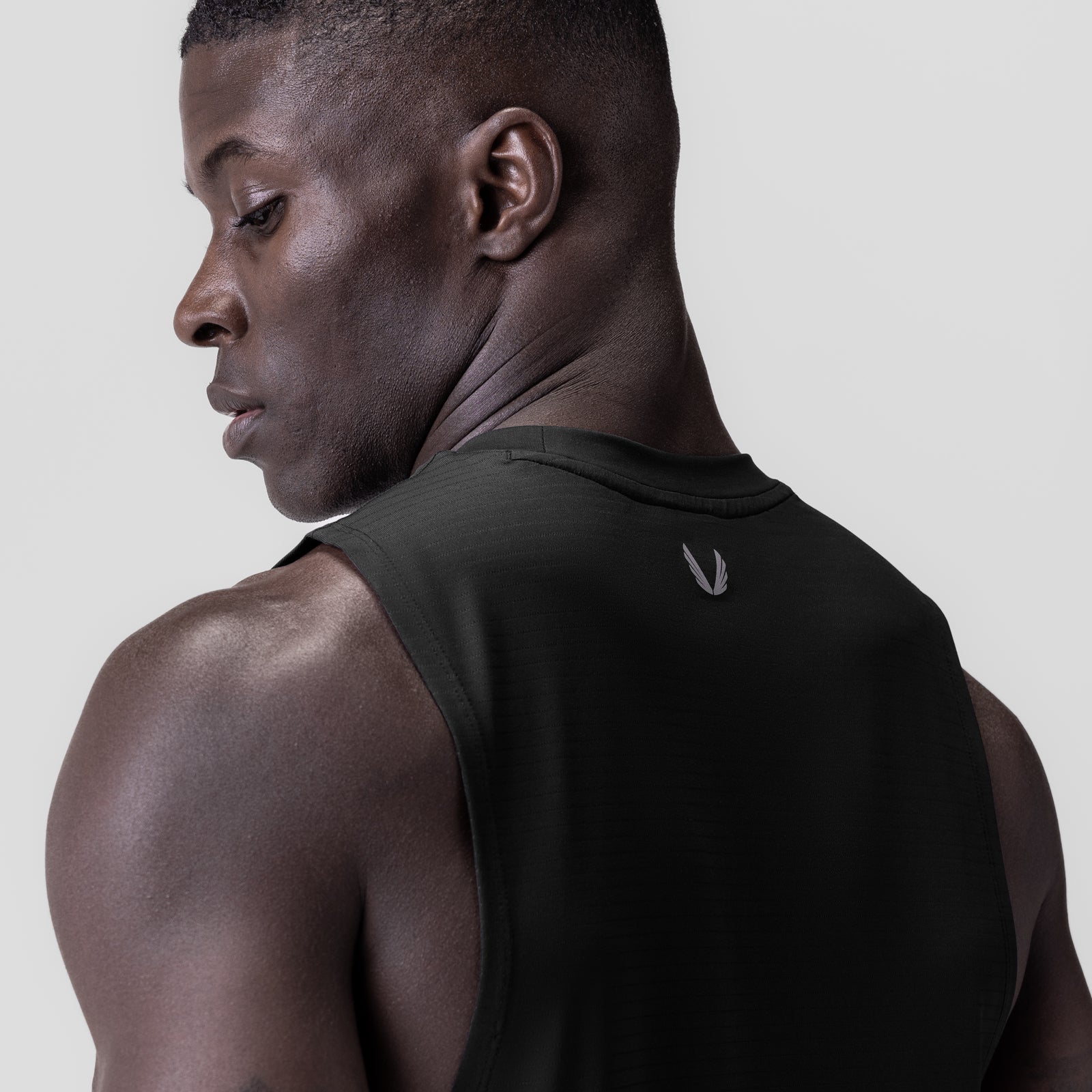 3D-Lite® 2.0 Lycra® Muscle Tank in black, worn by model in profile view