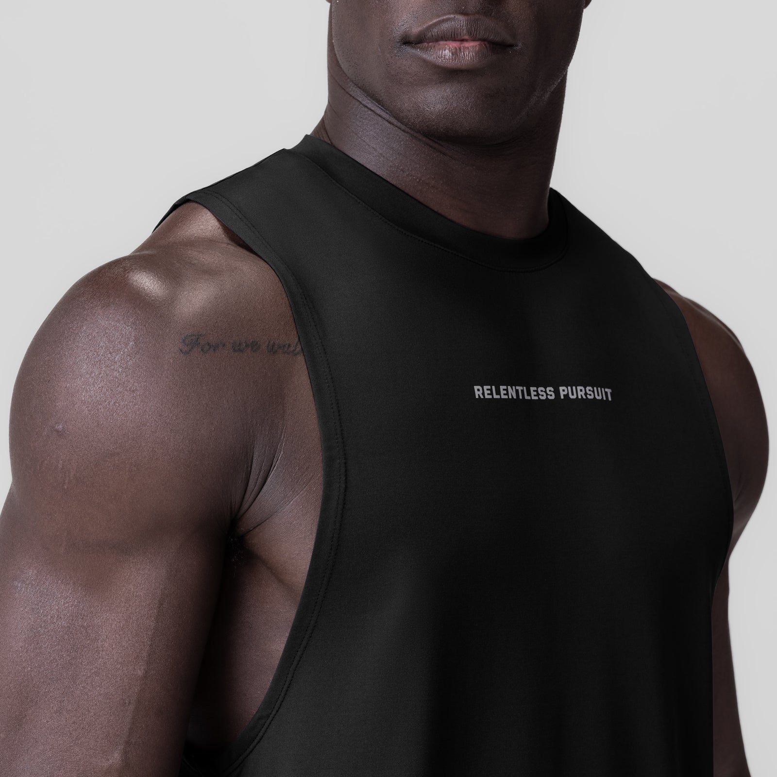 Black 3D-Lite® 2.0 Lycra® Muscle Tank with 'RELENTLESS PURSUIT' text, worn by model