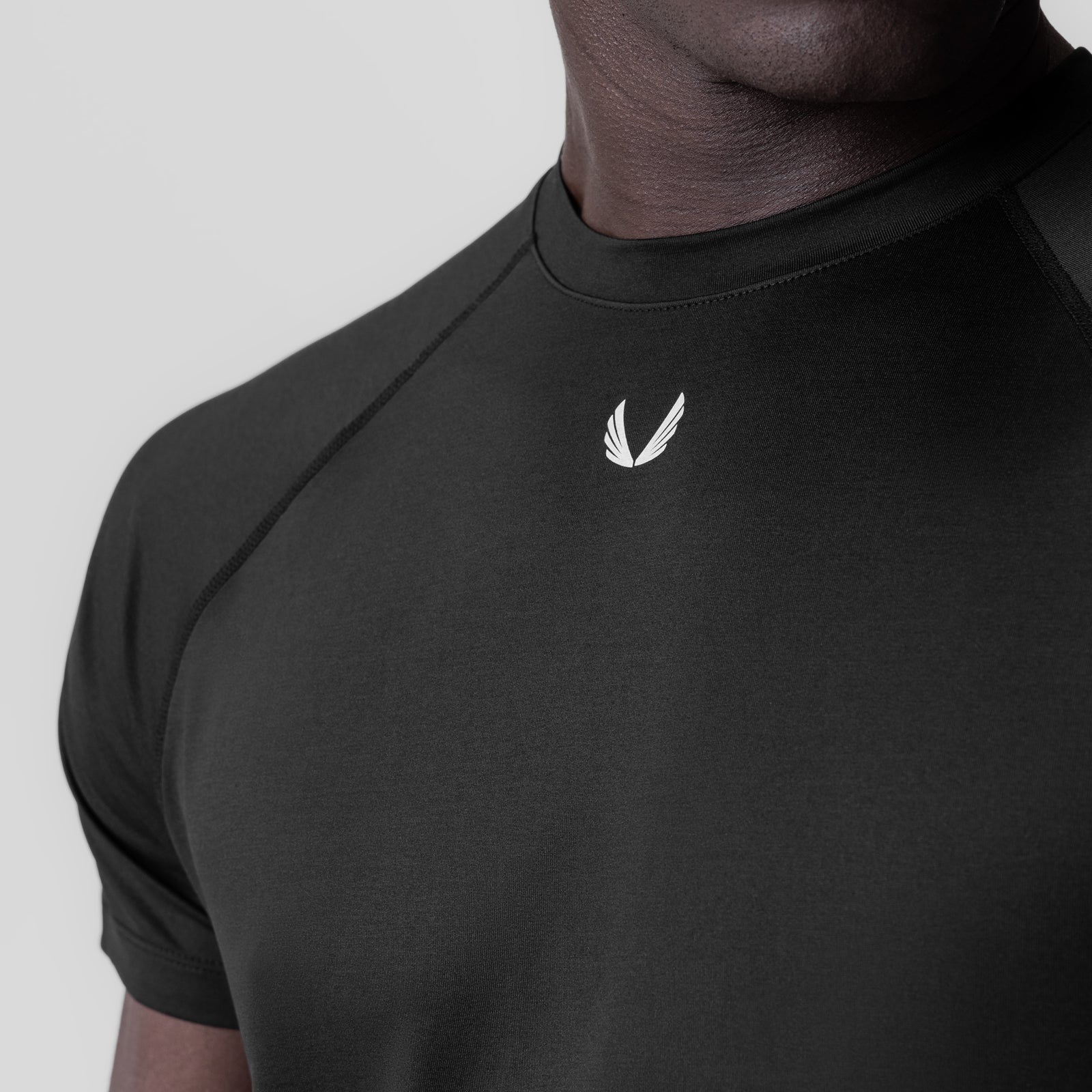 Black 3D-Lite® 2.0 Lycra® Fitted Tee worn by model, chest detail with white logo