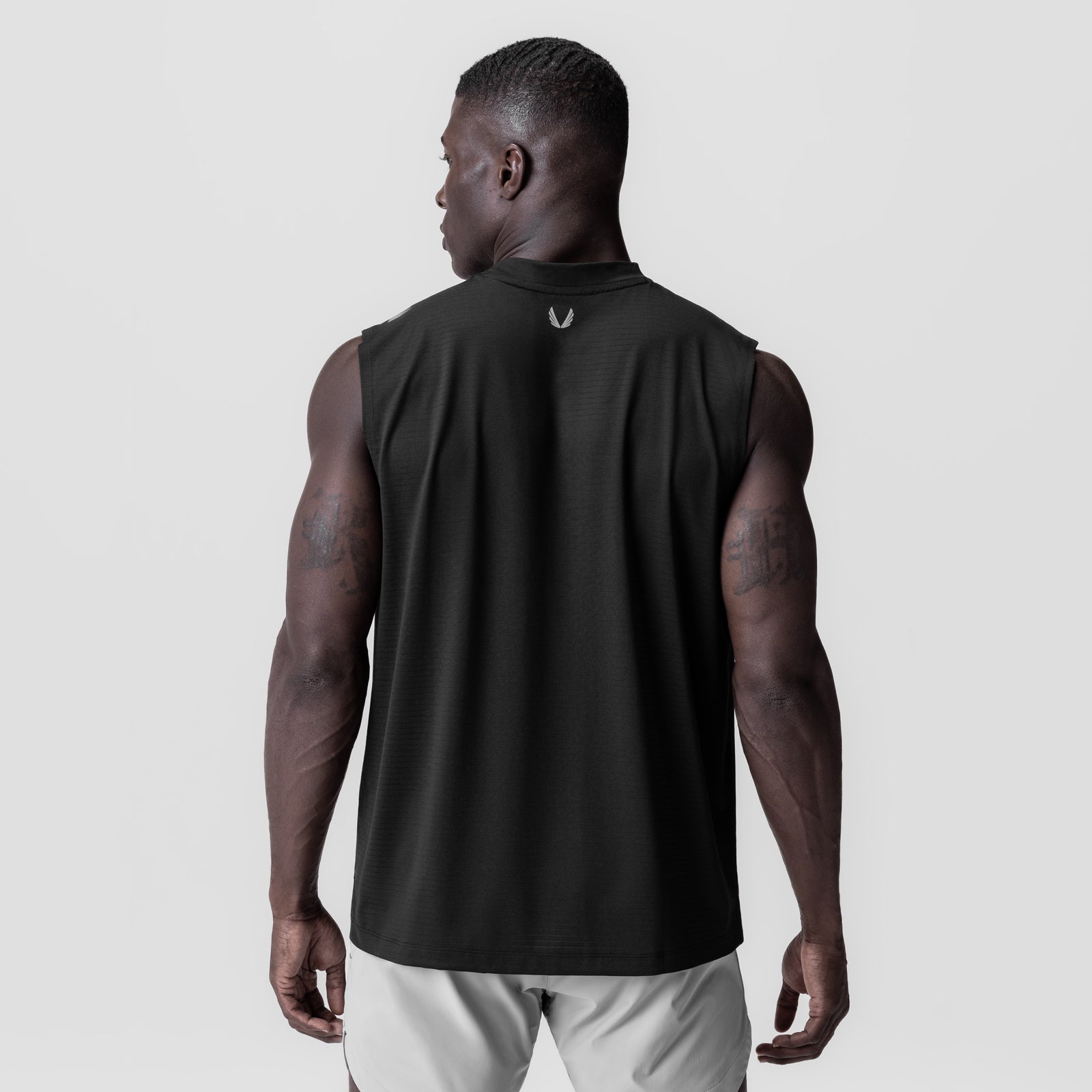 Black 3D-Lite® 2.0 Lycra® Relaxed Cutoff tank top on model, back view