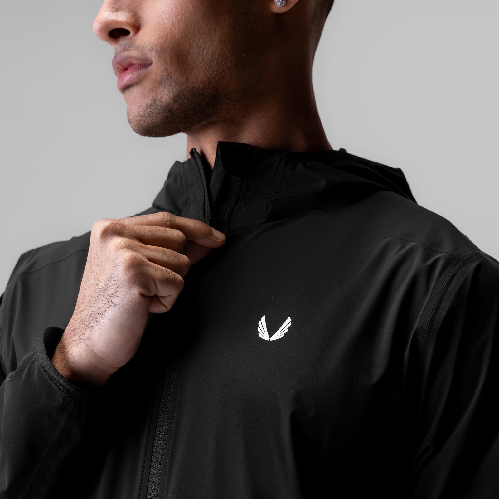 Black Aerotex Lightweight Windbreaker worn by male model, front view with hand at chest