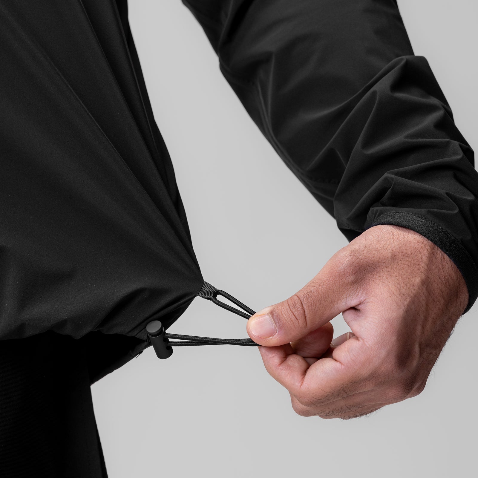 Black Aerotex Lightweight Windbreaker worn by model, closeup of drawstring detail