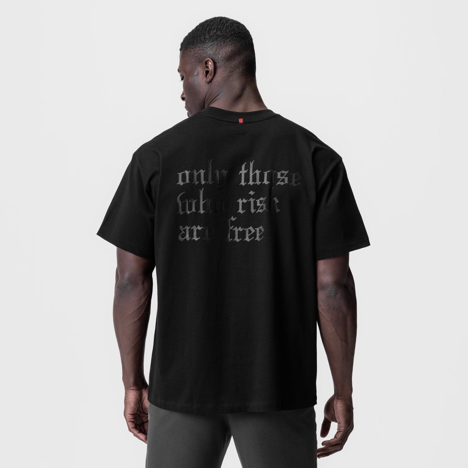 Black Tech Essential Relaxed Tee with 'OTWR' graphic, back view on model