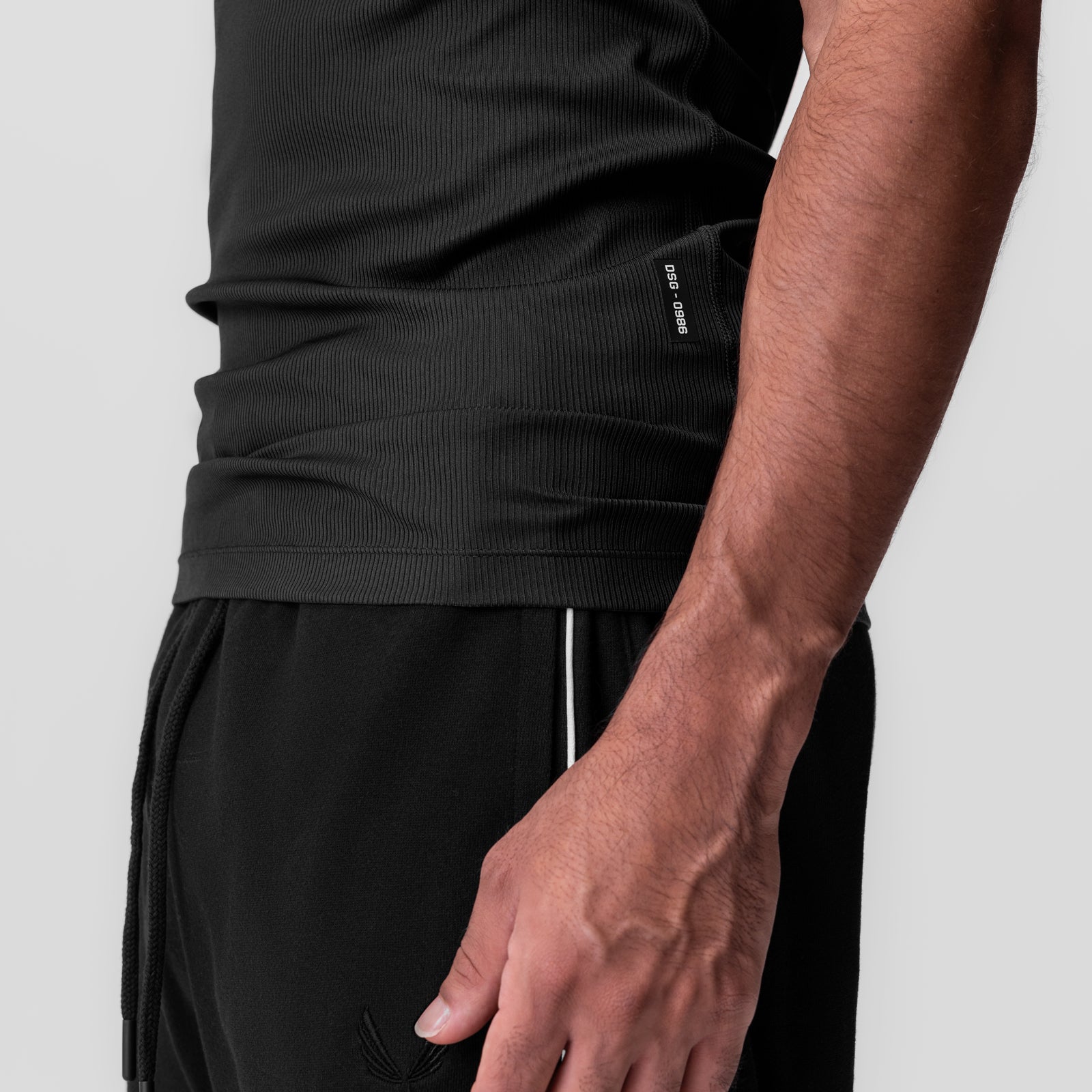 Creora® Tech Ribbed Tank in black worn by model, side detail view