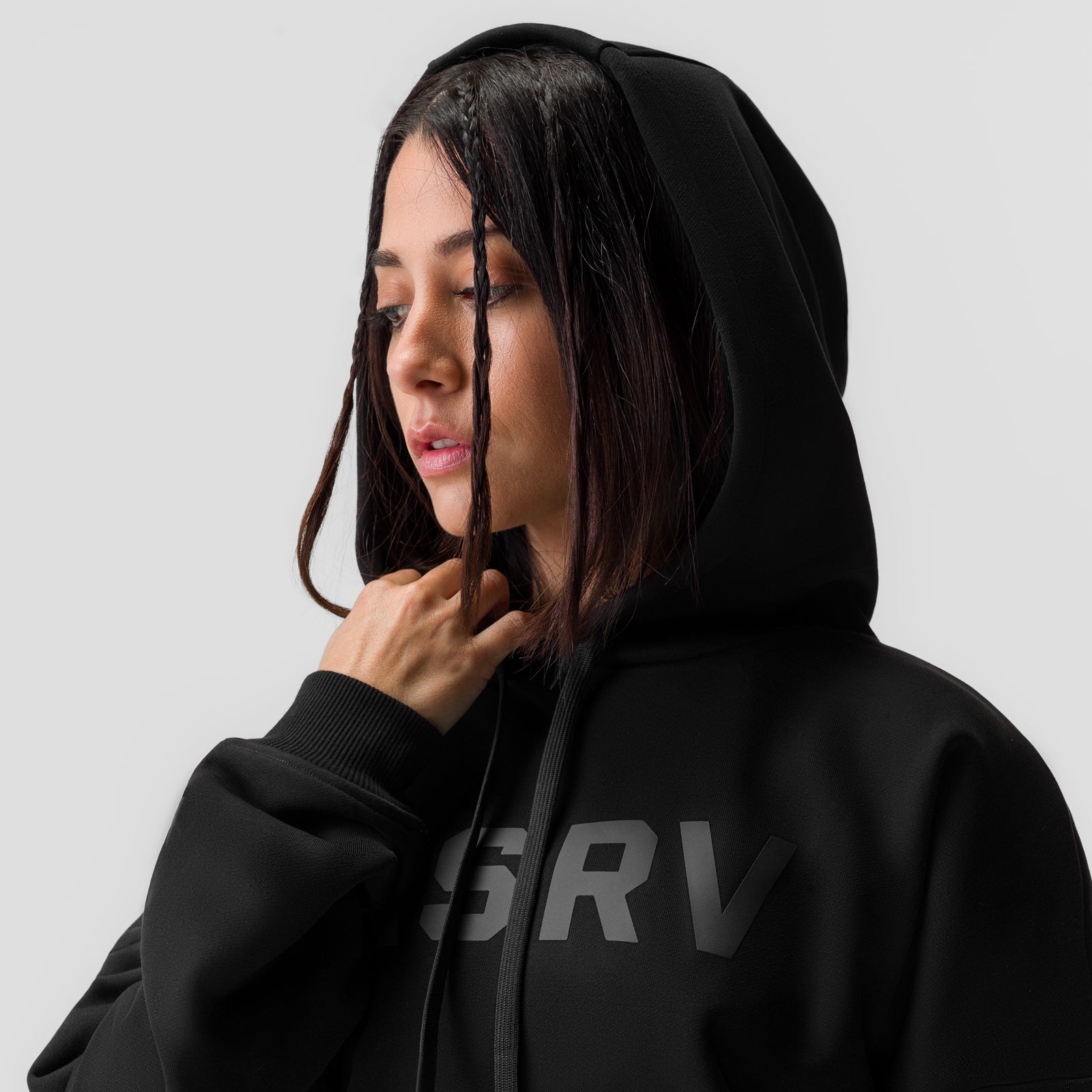 Black ASRV x Equinox cropped hoodie worn by model, hooded profile view