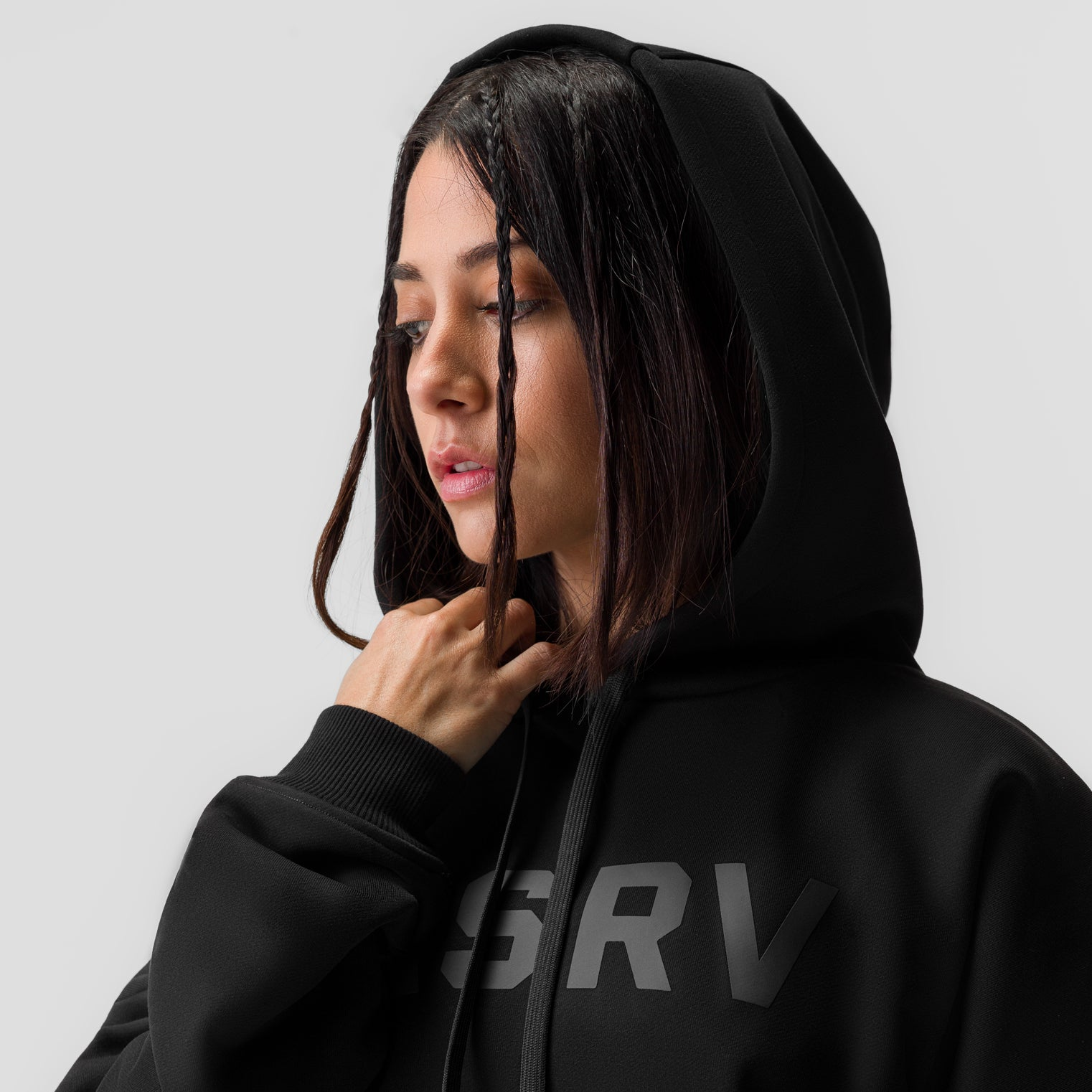 Black cropped hoodie worn by model with hood up, front view