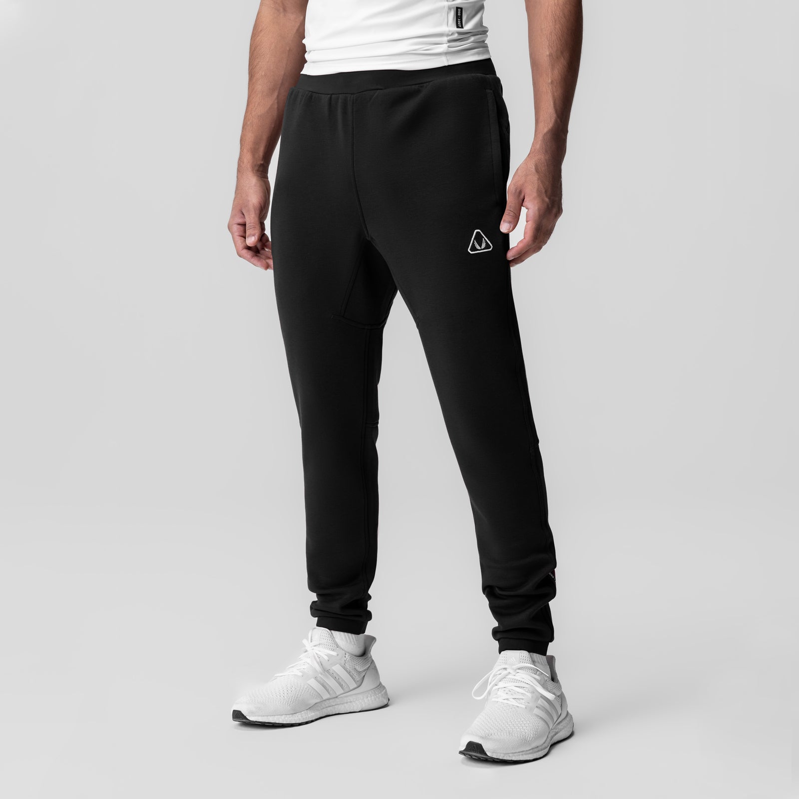 Black Dri-Core Training Jogger worn by model with white sneakers, front view