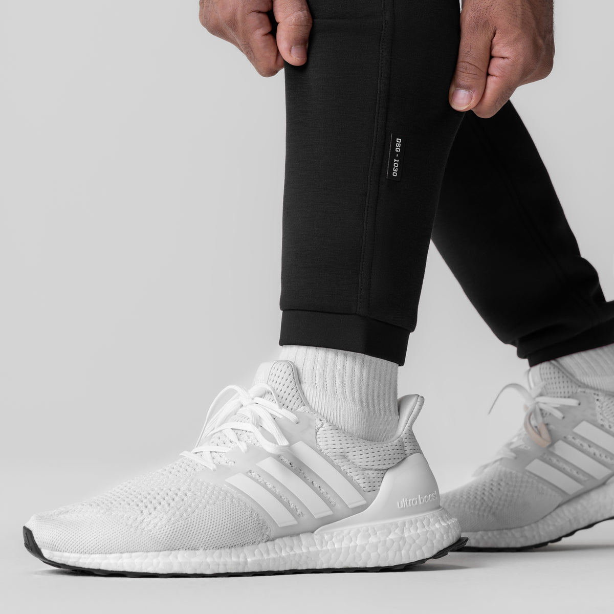 Black Dri-Core Training Jogger worn with white socks and sneakers, side view
