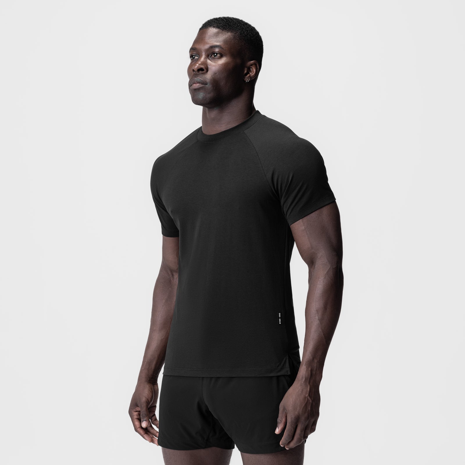 Black Supima fitted tee worn by model, front three-quarter view