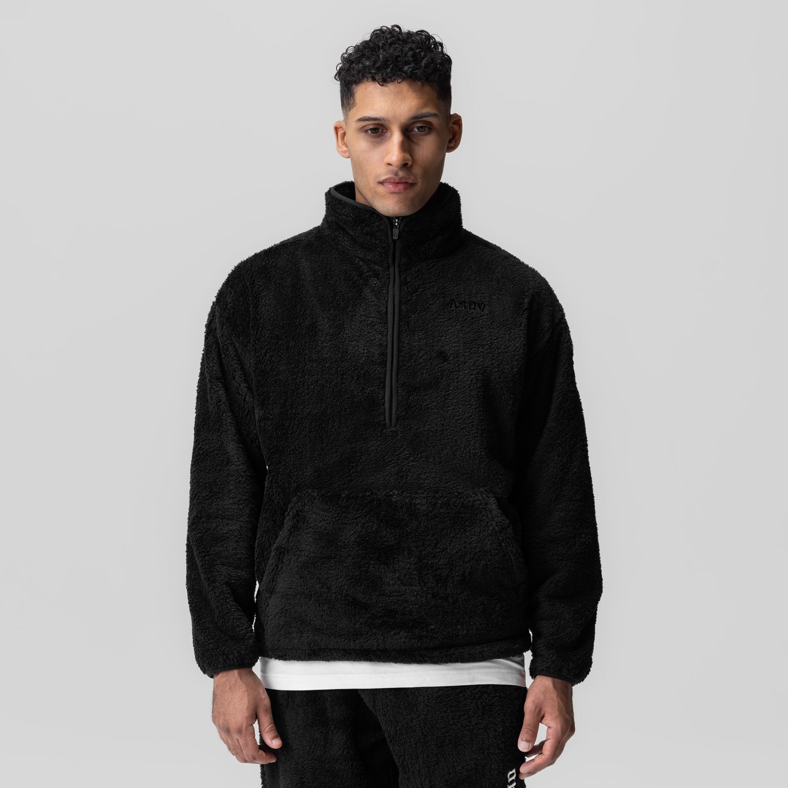Black Sherpa Recovery 1/2 Zip worn by model, front view with white undershirt