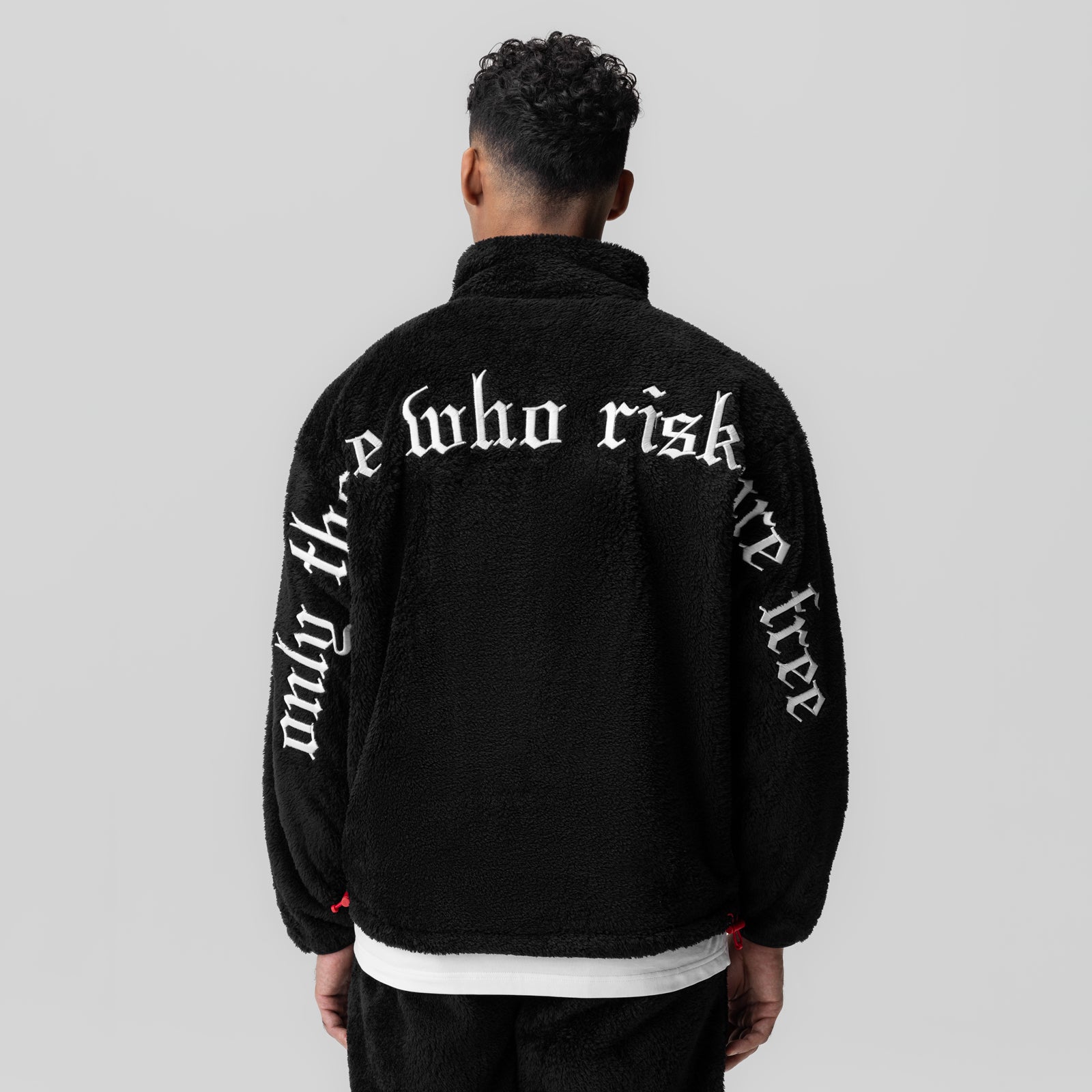 Sherpa Recovery 1/2 Zip jacket in black with white text, back view on model