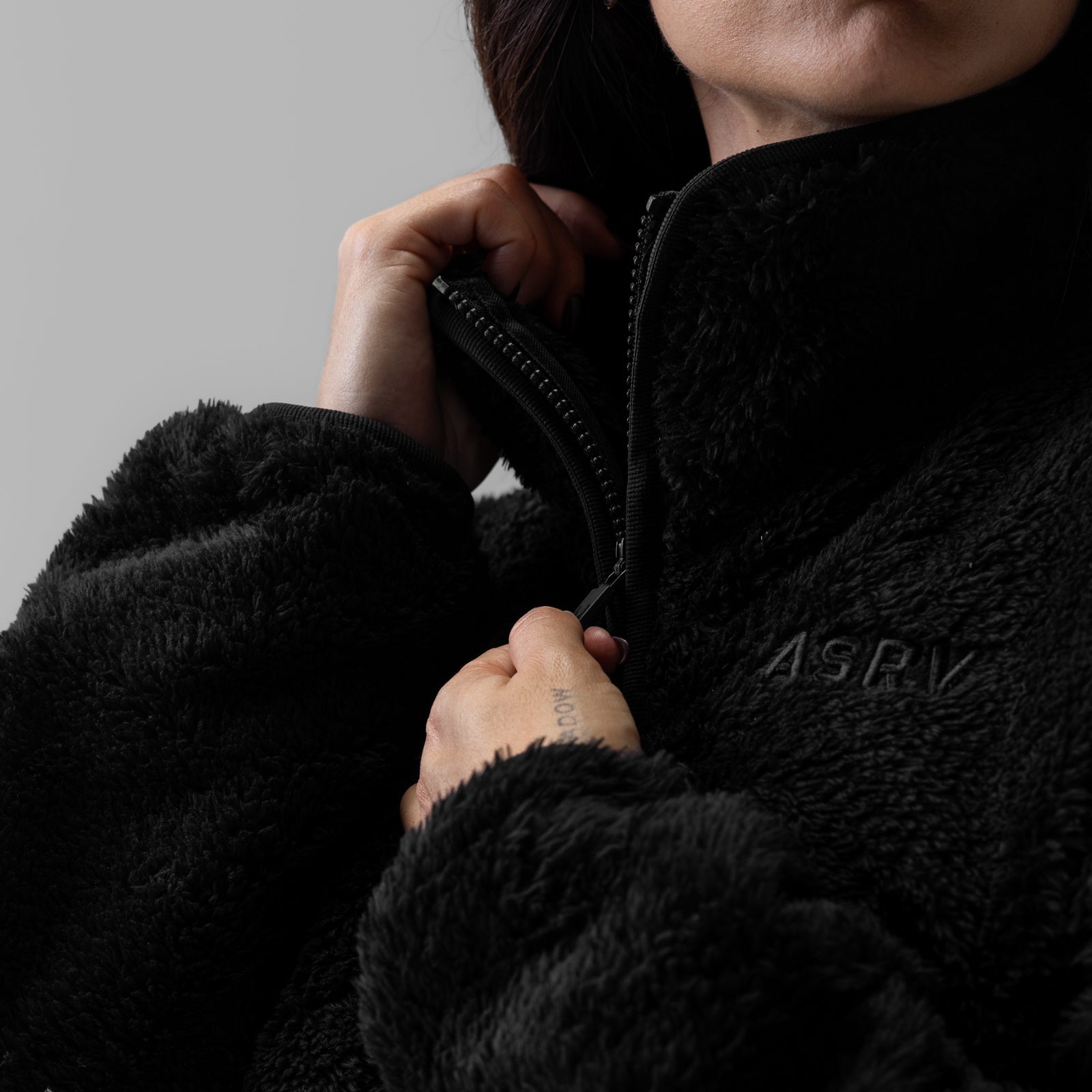 Women's Sherpa Recovery 1/2 Zip in black, worn and held by model against gray background