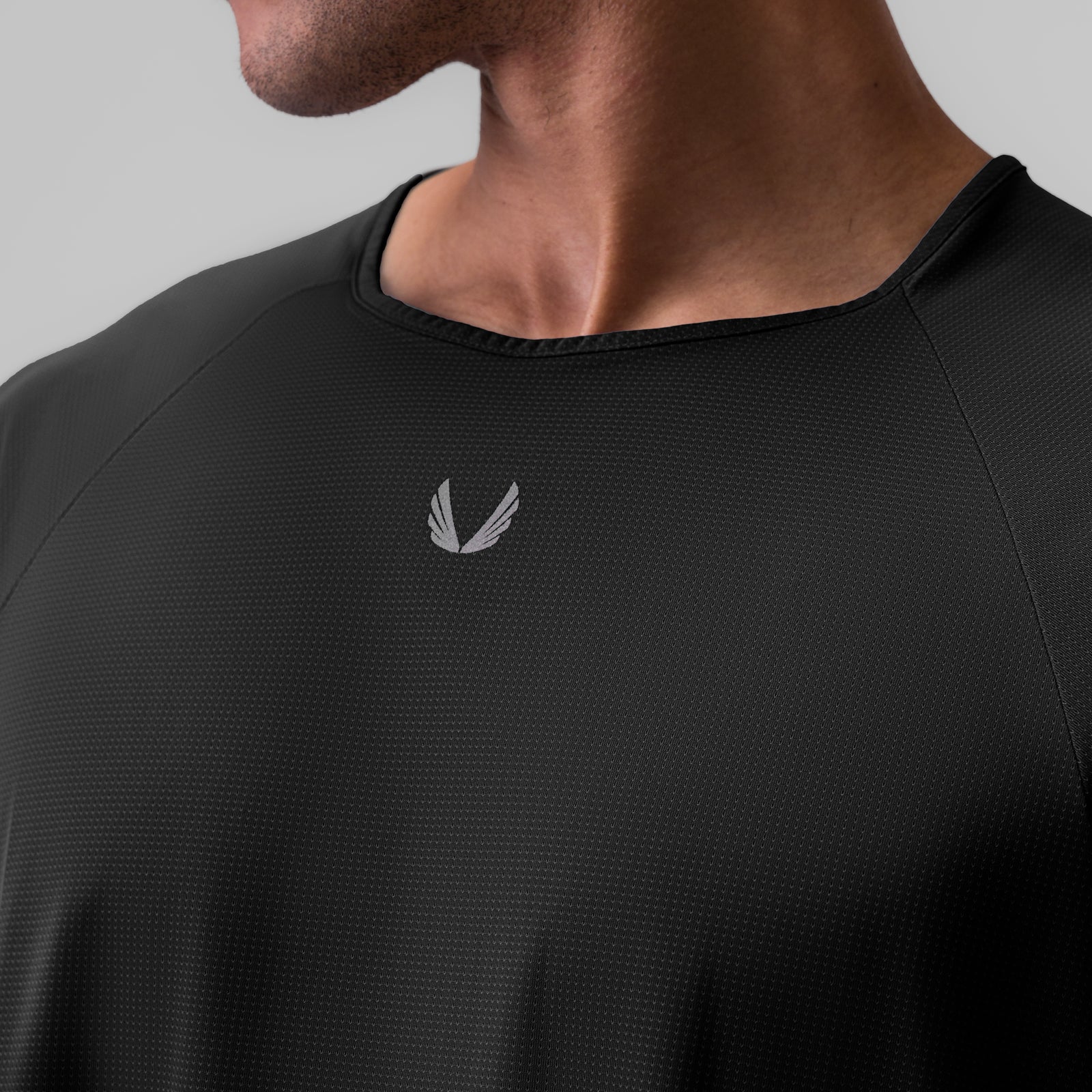 Ice-Skin™ Oversized Tee in black worn by model, chest detail with logo