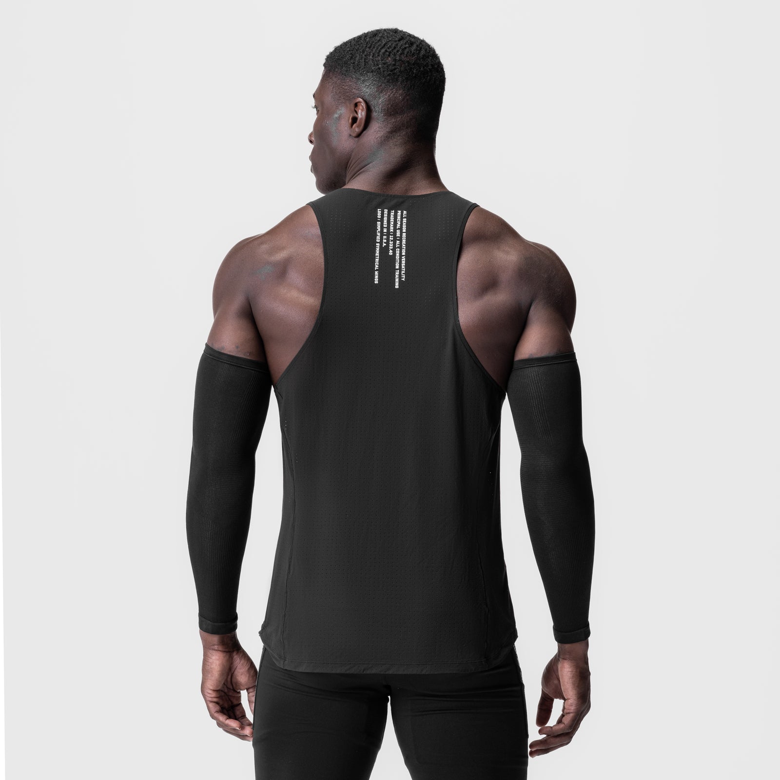 Black Laser-Vent™ Singlet Tank worn by model, back view with arm sleeves