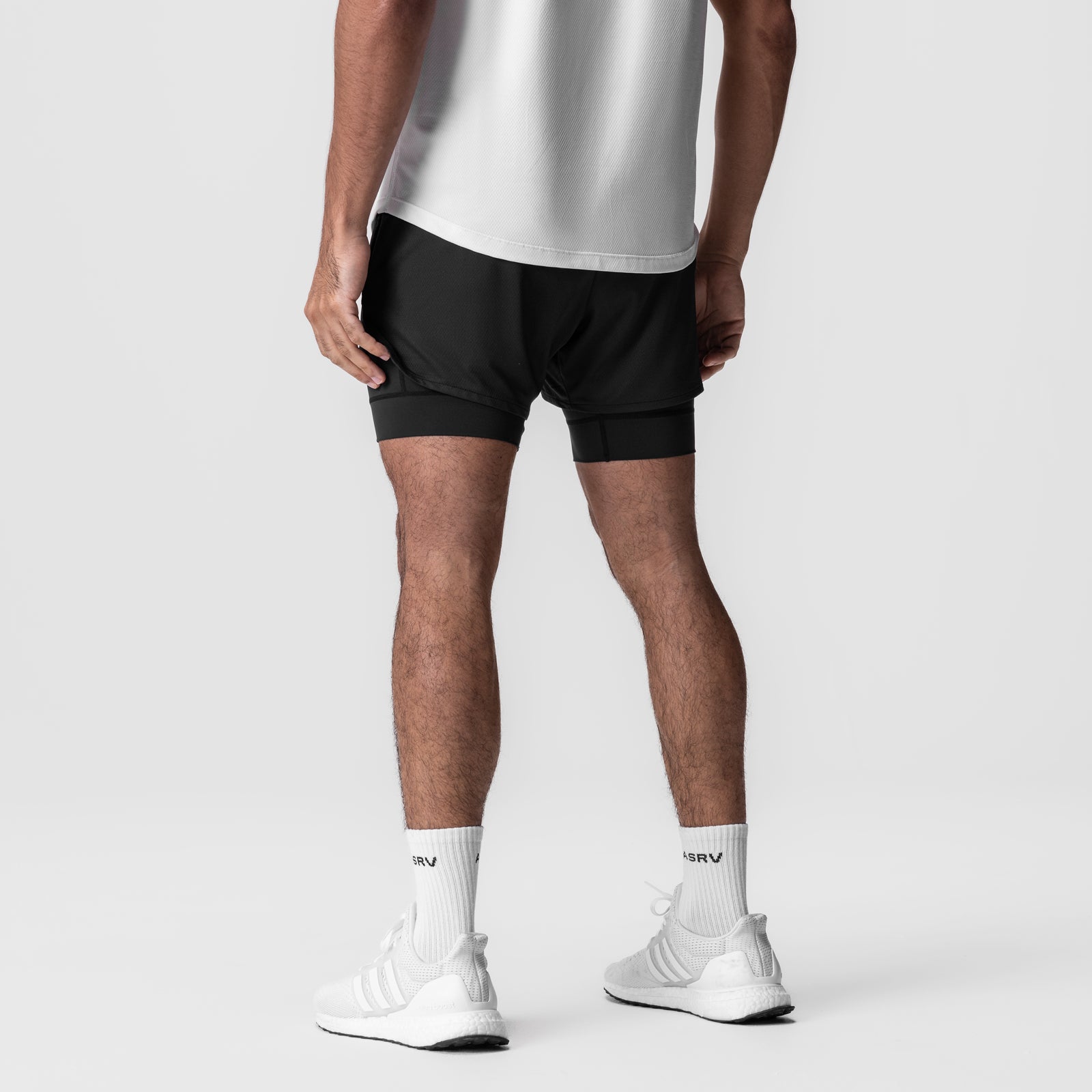 AeroSilver 5" Liner Short in black, worn by model with white socks, back view