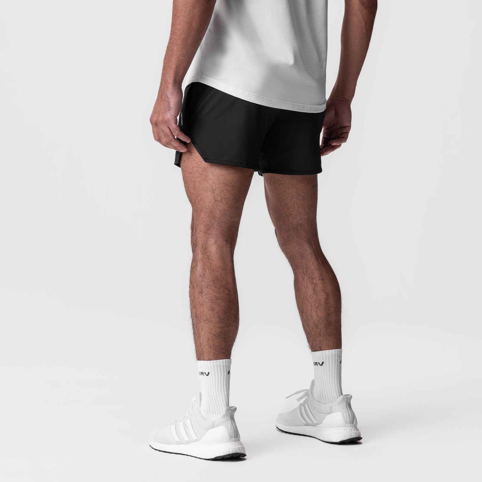 AeroSilver 5" Linerless Short in black, worn by model with white socks and sneakers, back view