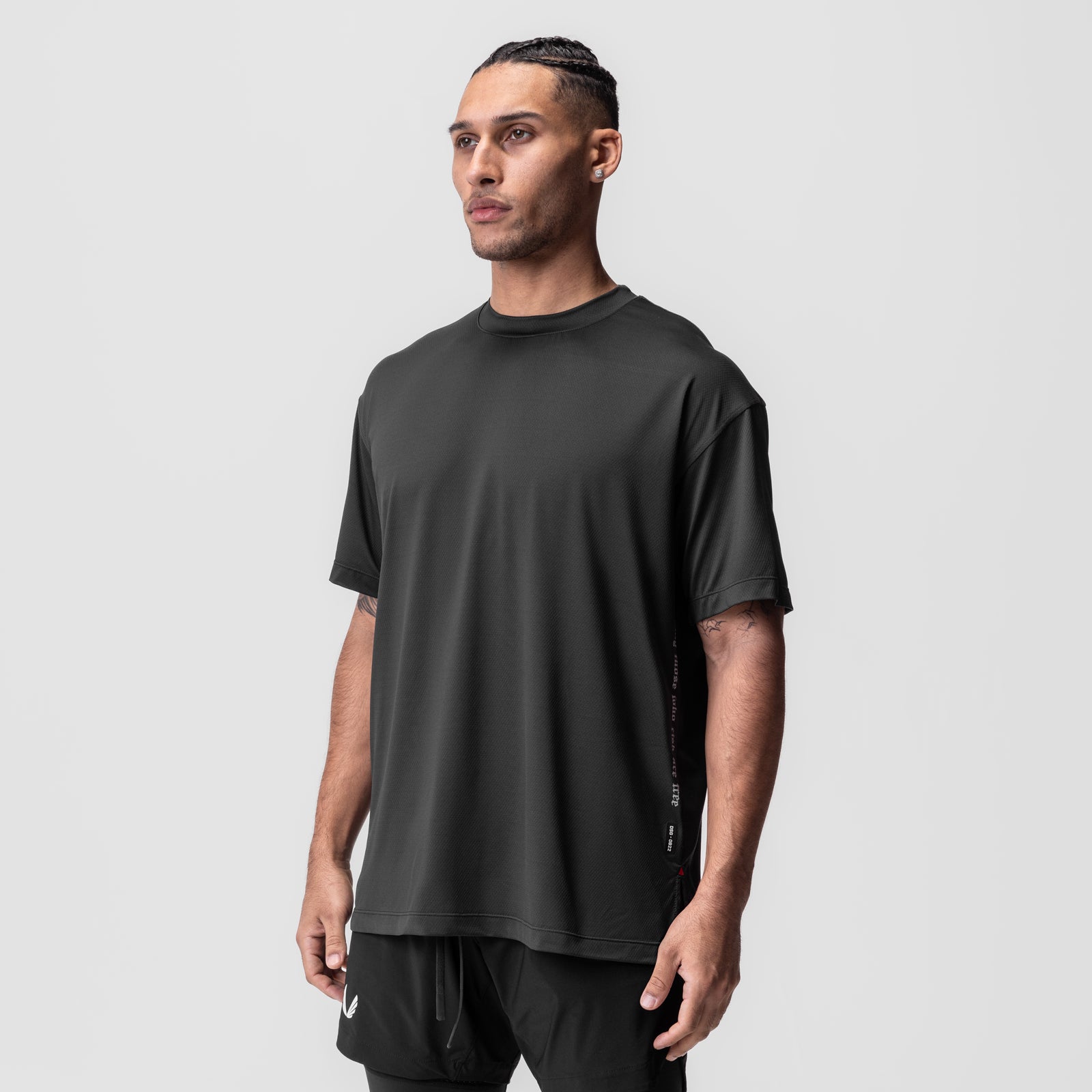 AeroSilver Oversized Tee in black worn by model, three-quarter front view