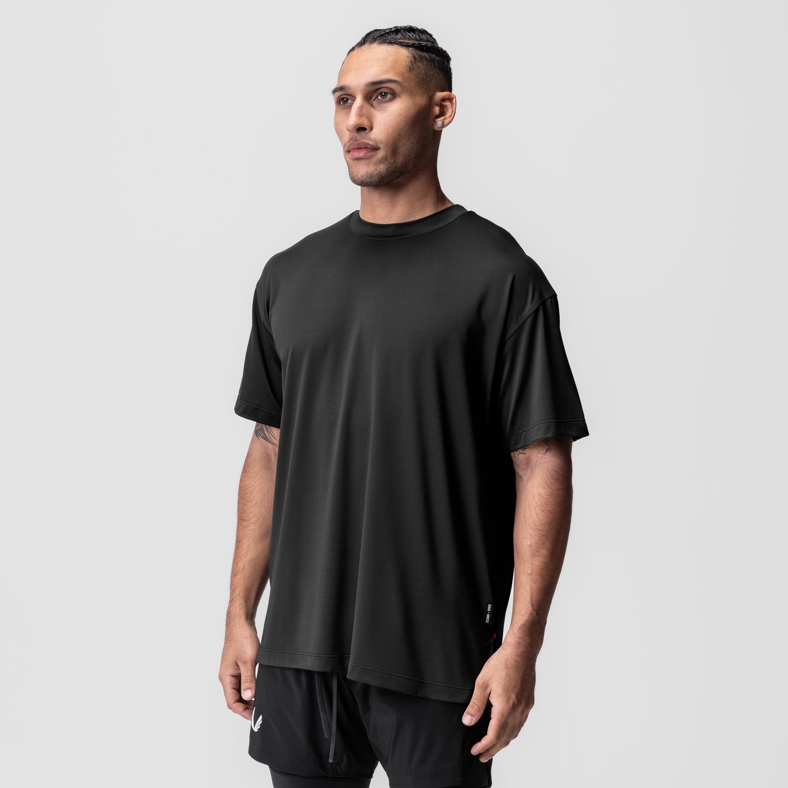 AeroSilver Oversized Tee in black, worn by model in three-quarter front view
