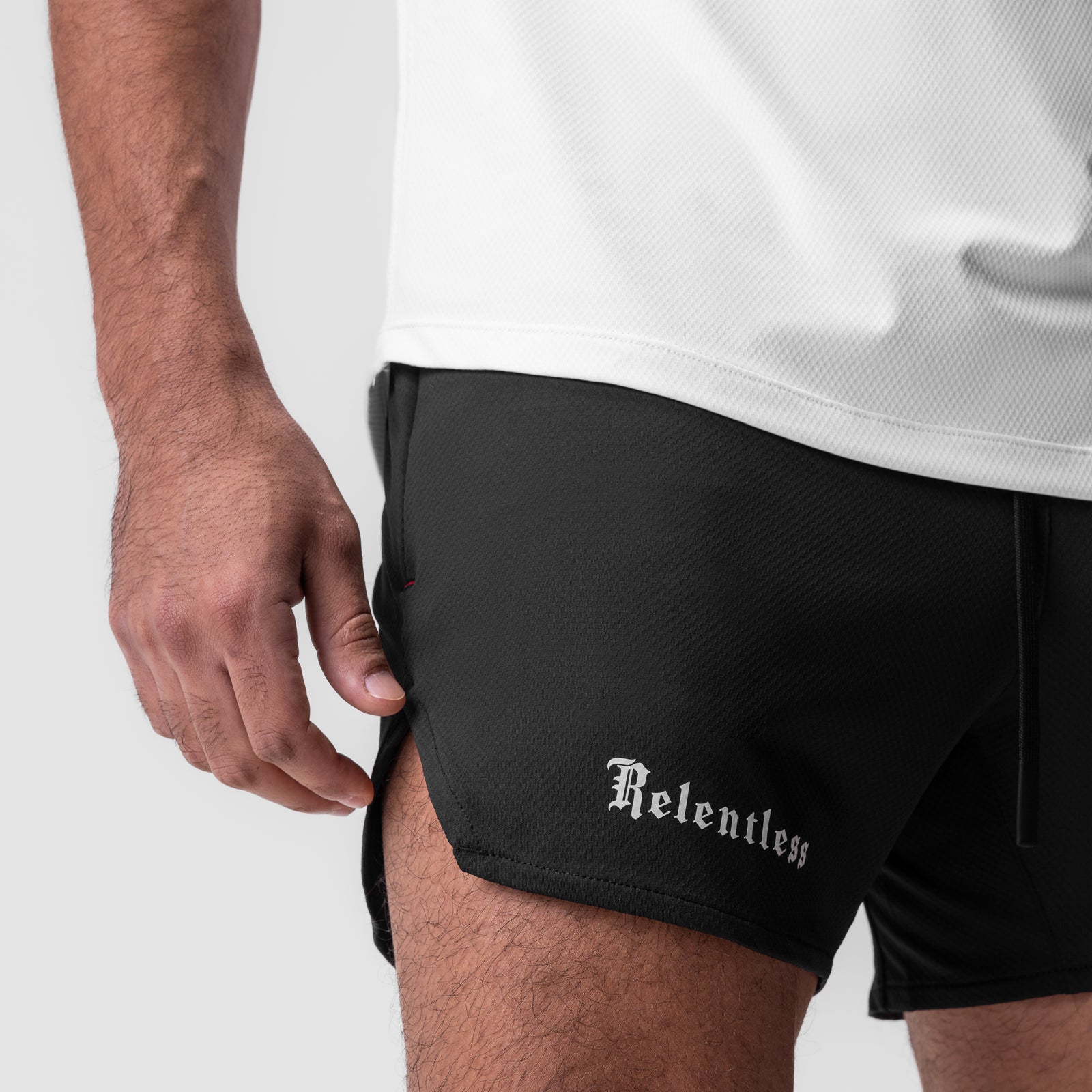 Black AeroSilver 5" linerless shorts worn by model, side view with hand in pocket