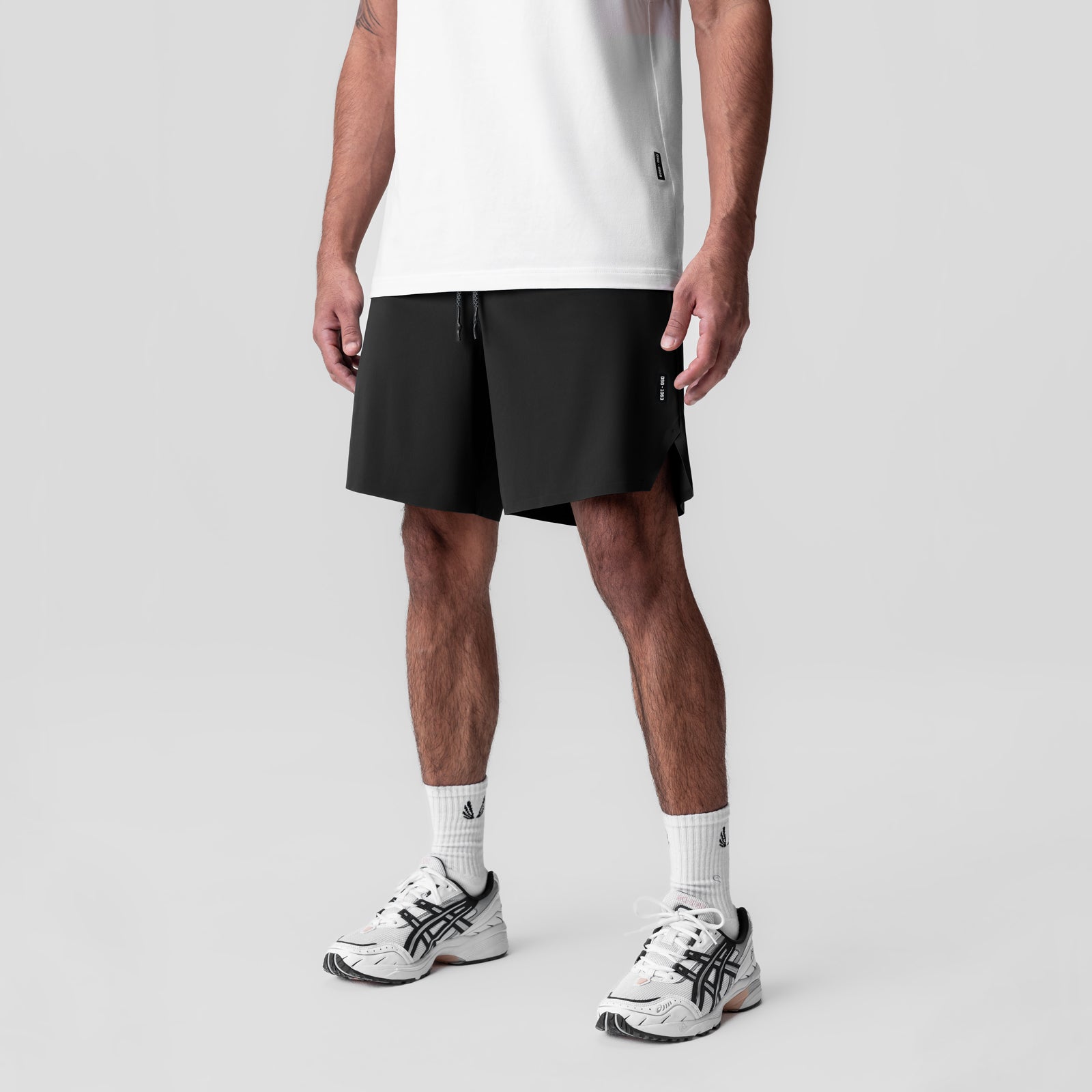 Black Revolutional Field Short worn with white tee and sneakers, front view on model