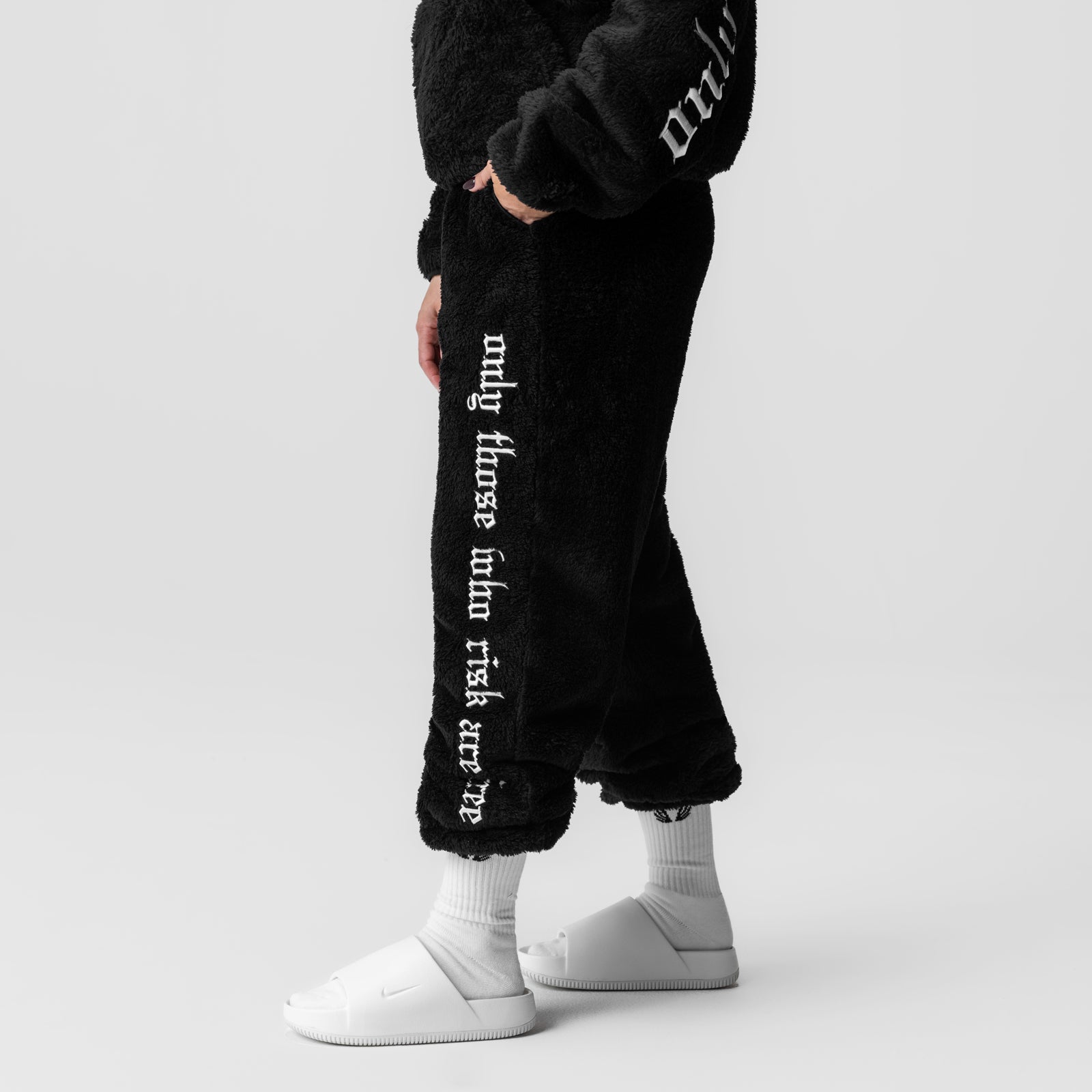 Women's Sherpa Recovery Sweats in black with white socks and shoes, side view on model