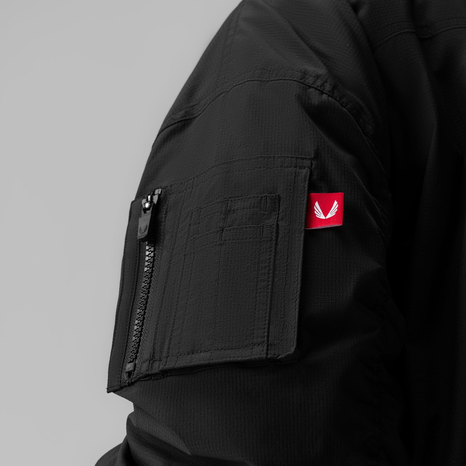 Women's Sherpa-Lined Insulated Bomber Jacket in black, worn on model, side detail view