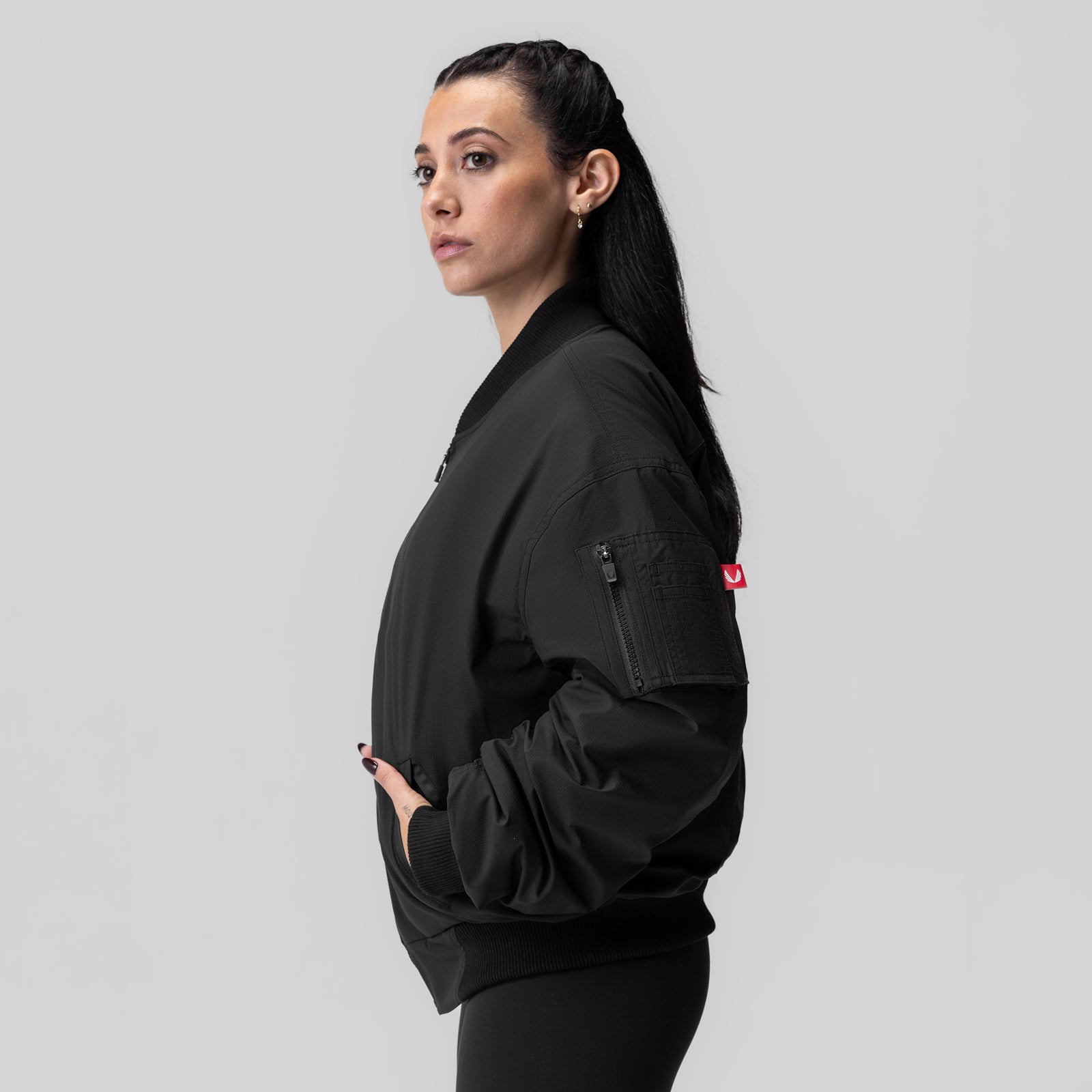 Women's Sherpa-Lined Insulated Bomber Jacket in black, worn by model in side profile pose