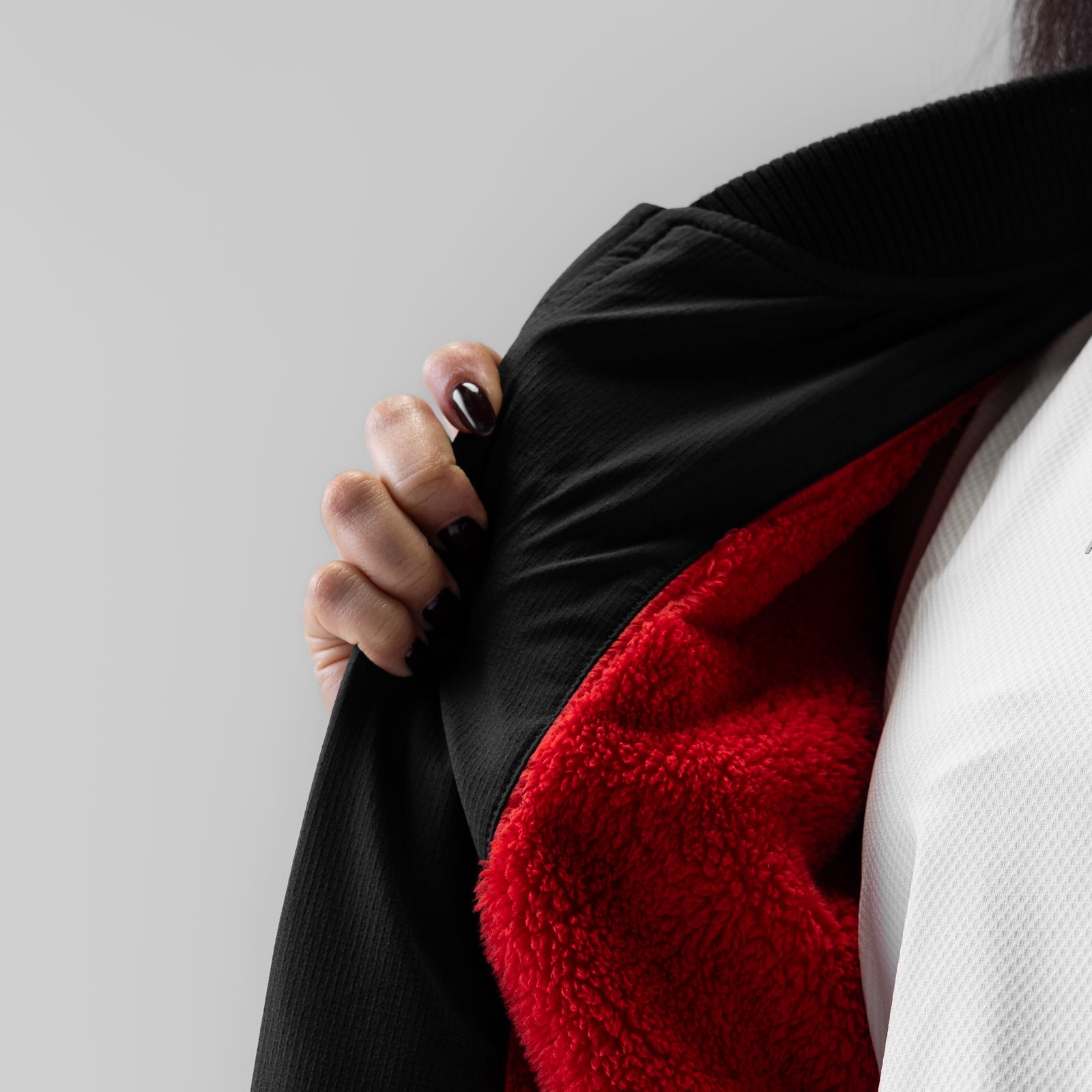 Women's Sherpa-Lined Insulated Bomber Jacket in Black, worn open to show red fleece lining