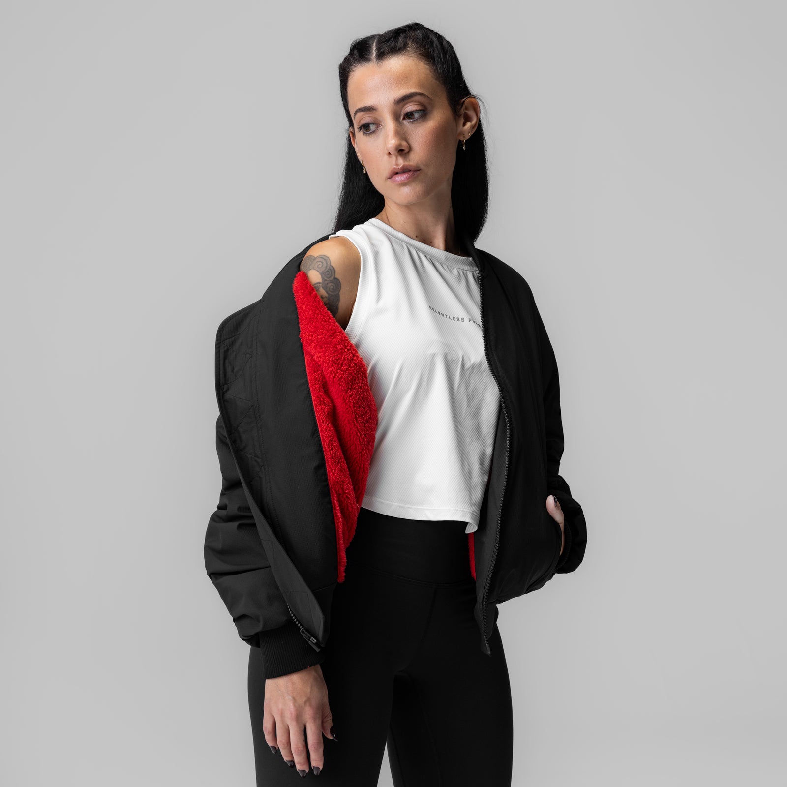 Women's Sherpa-Lined Insulated Bomber Jacket in black with red sherpa lining, worn by model