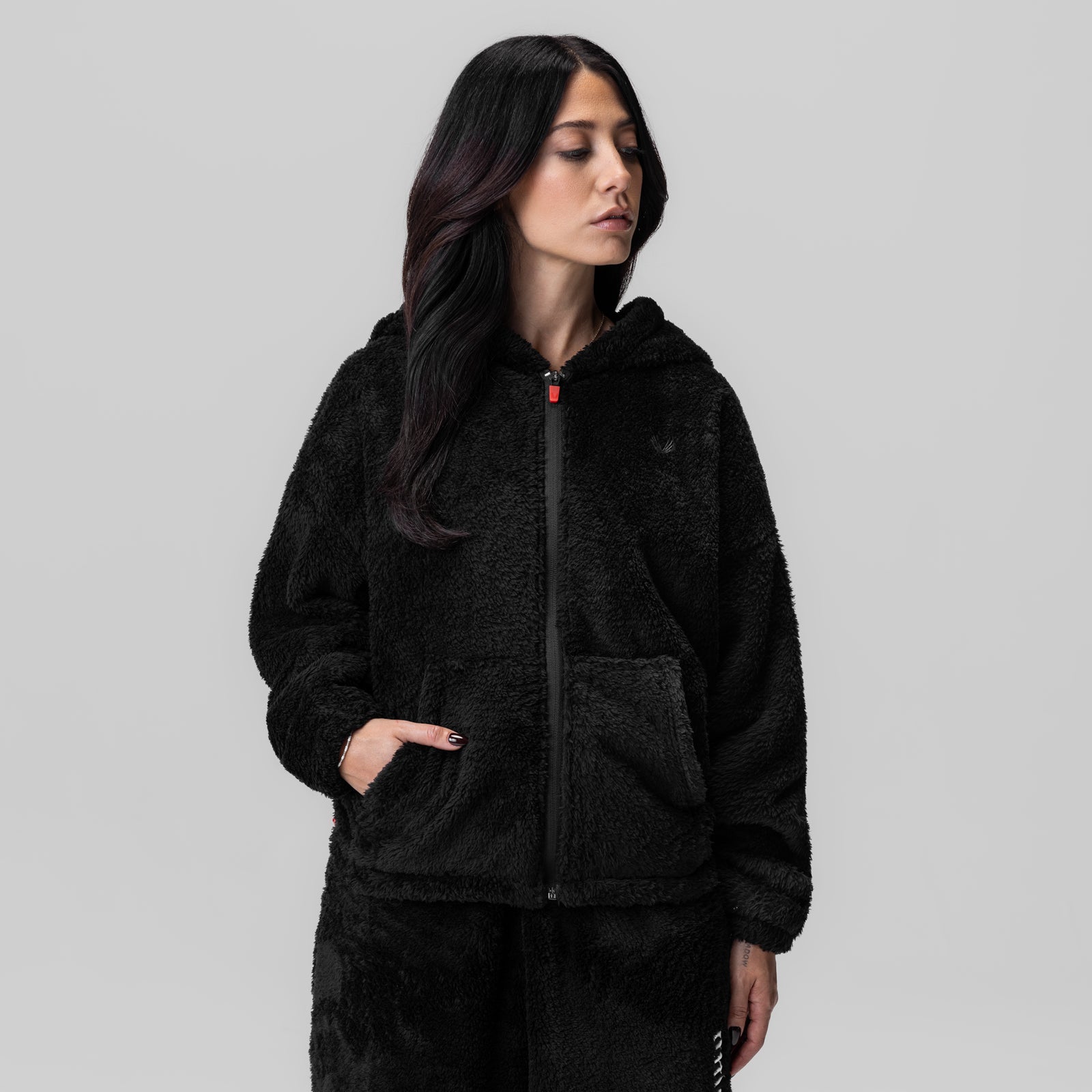 Women's Sherpa Recovery Full Zip Hoodie in black, worn by model looking away
