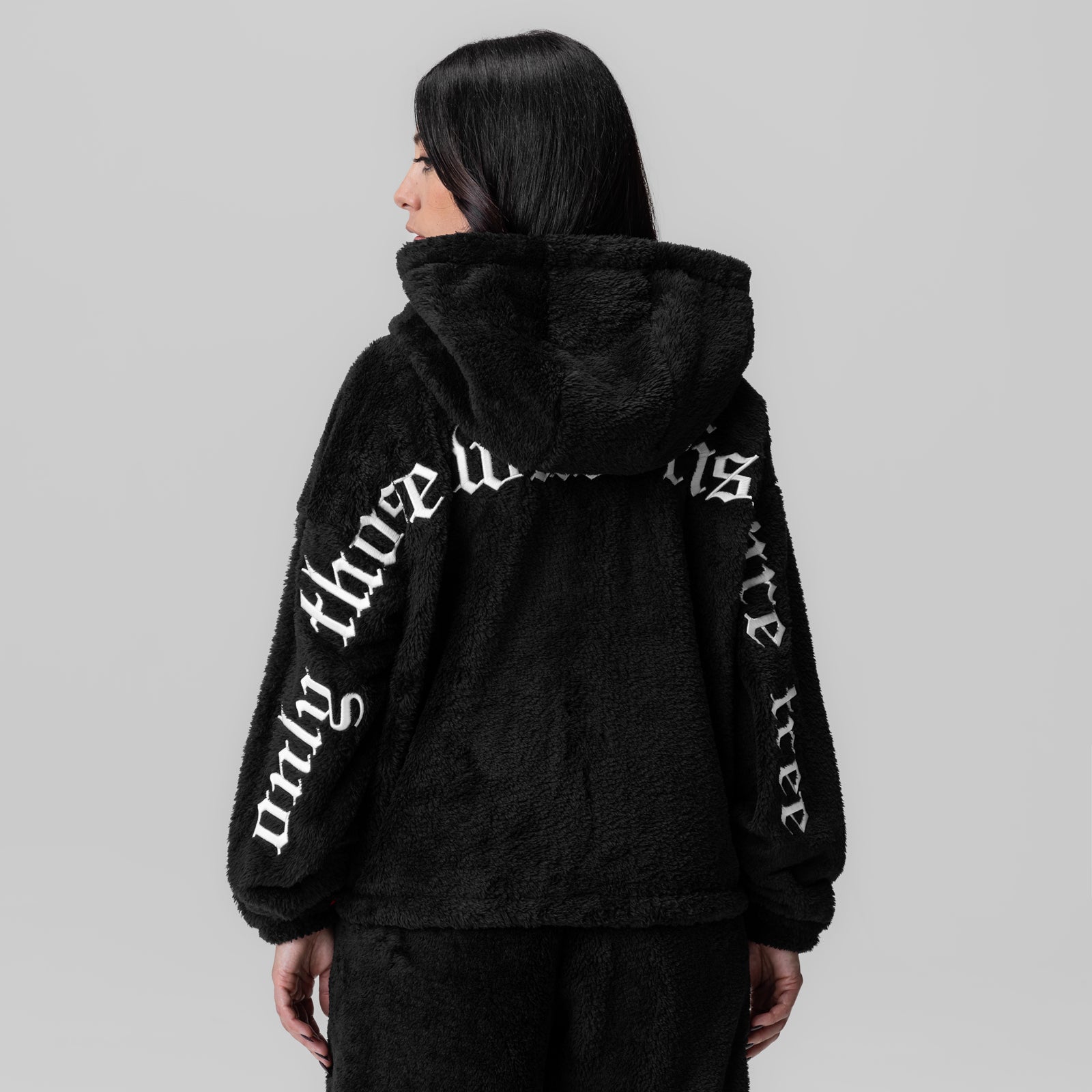 Women's Sherpa Recovery Full Zip Hoodie in black with white text, back view on model