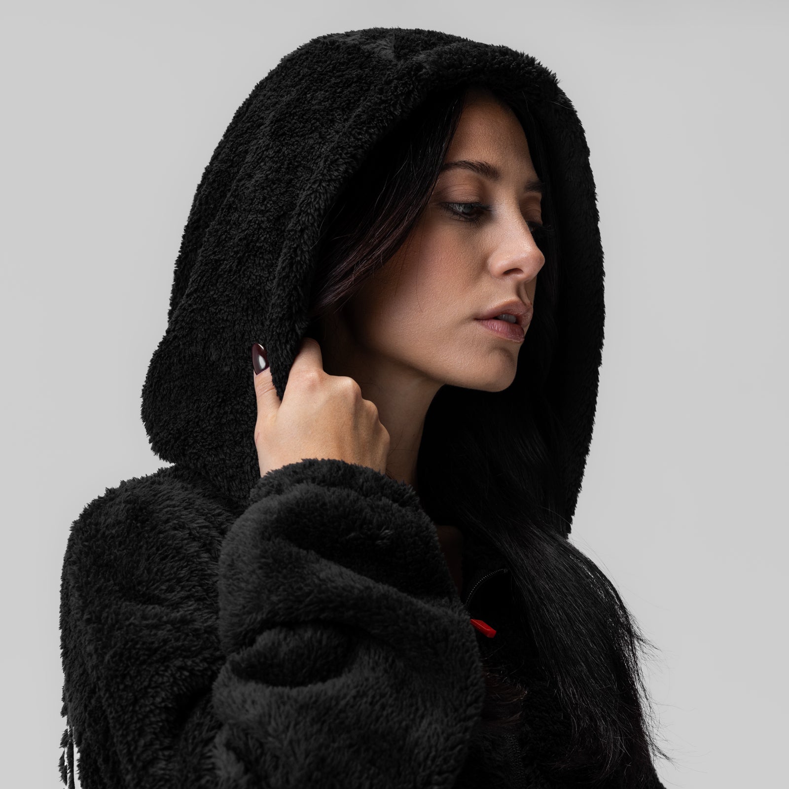 Women's Sherpa Recovery Full Zip Hoodie in black, worn by model in profile pose