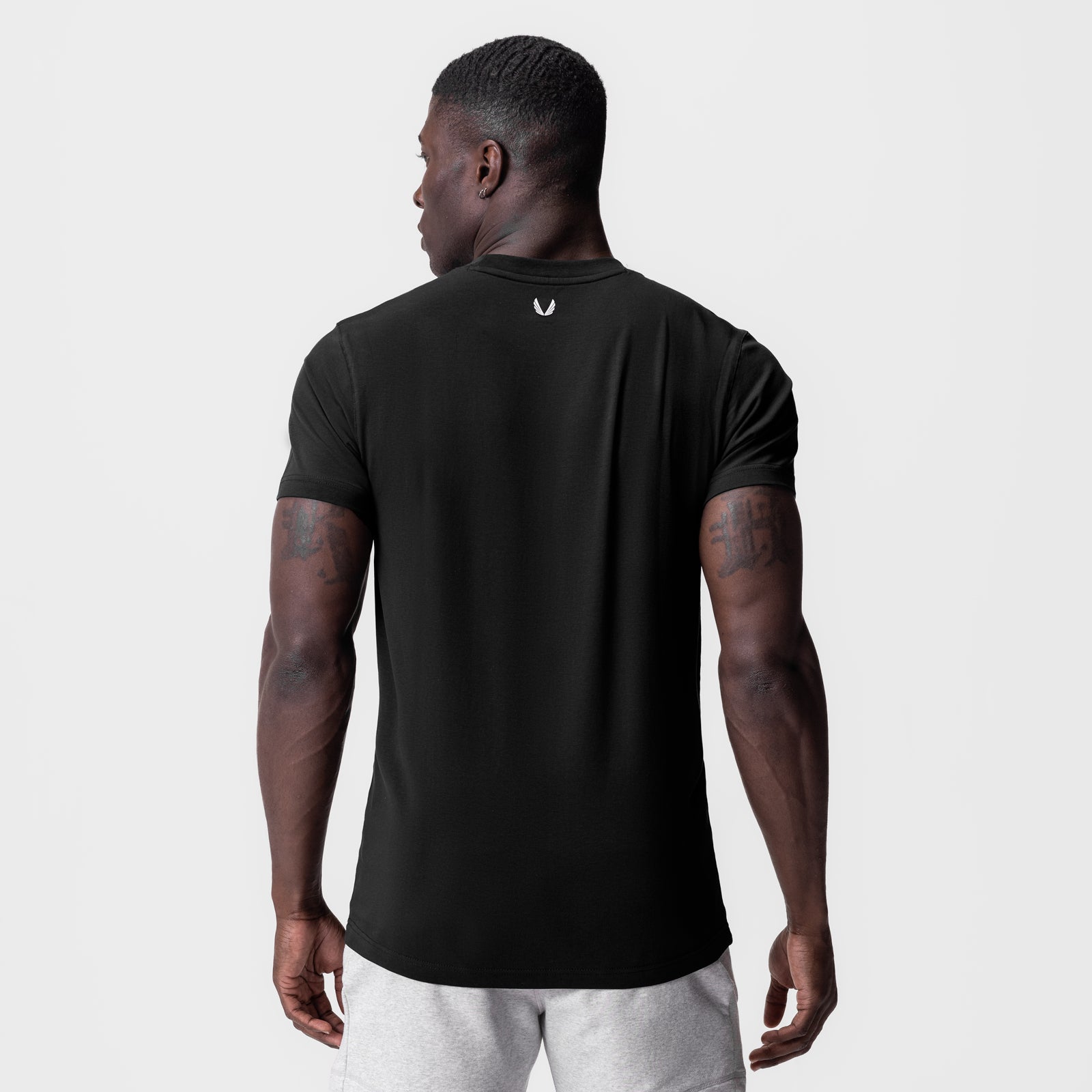Black Supima Essential Tee worn by model, back view