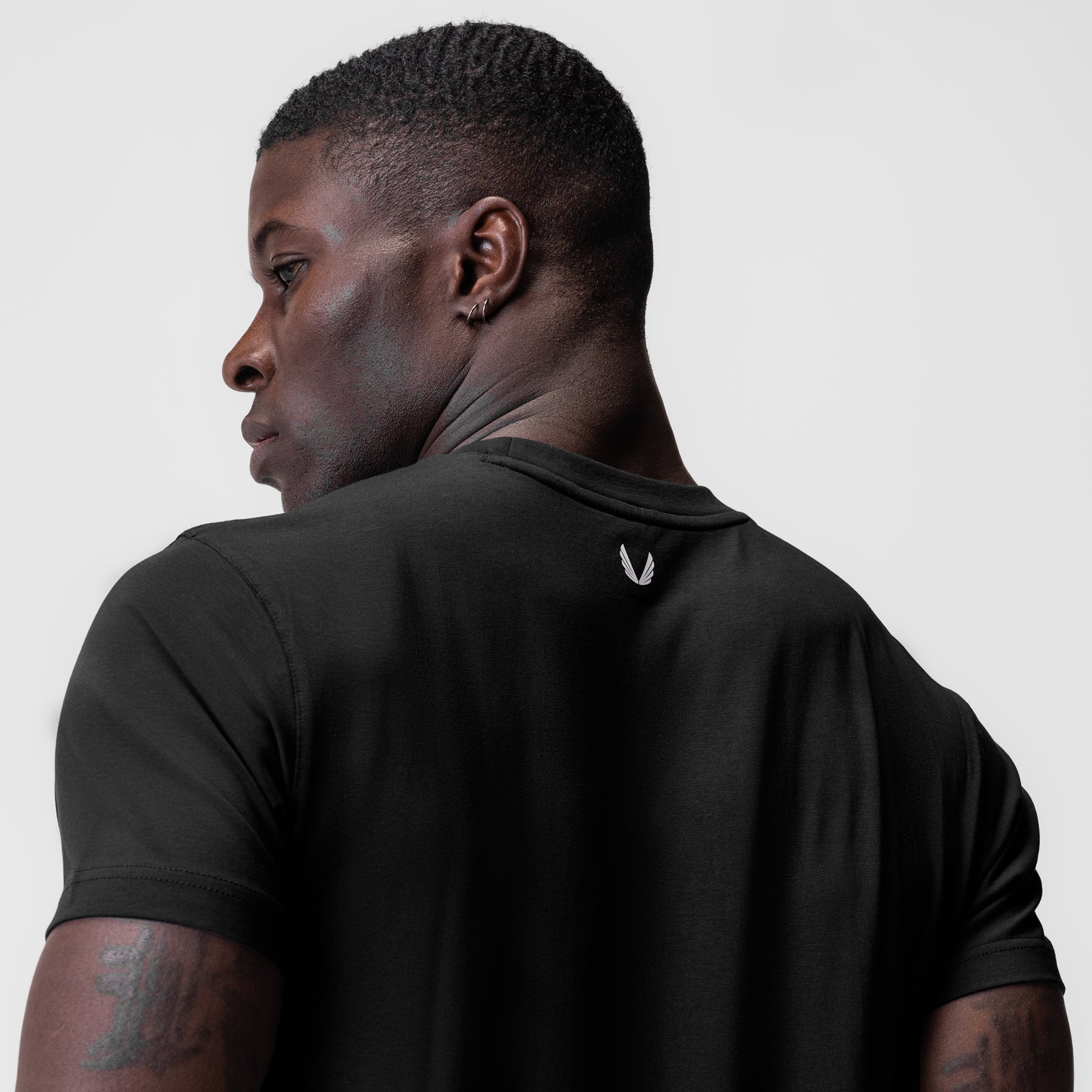 Black Supima Essential Tee worn by model, shown from back profile view