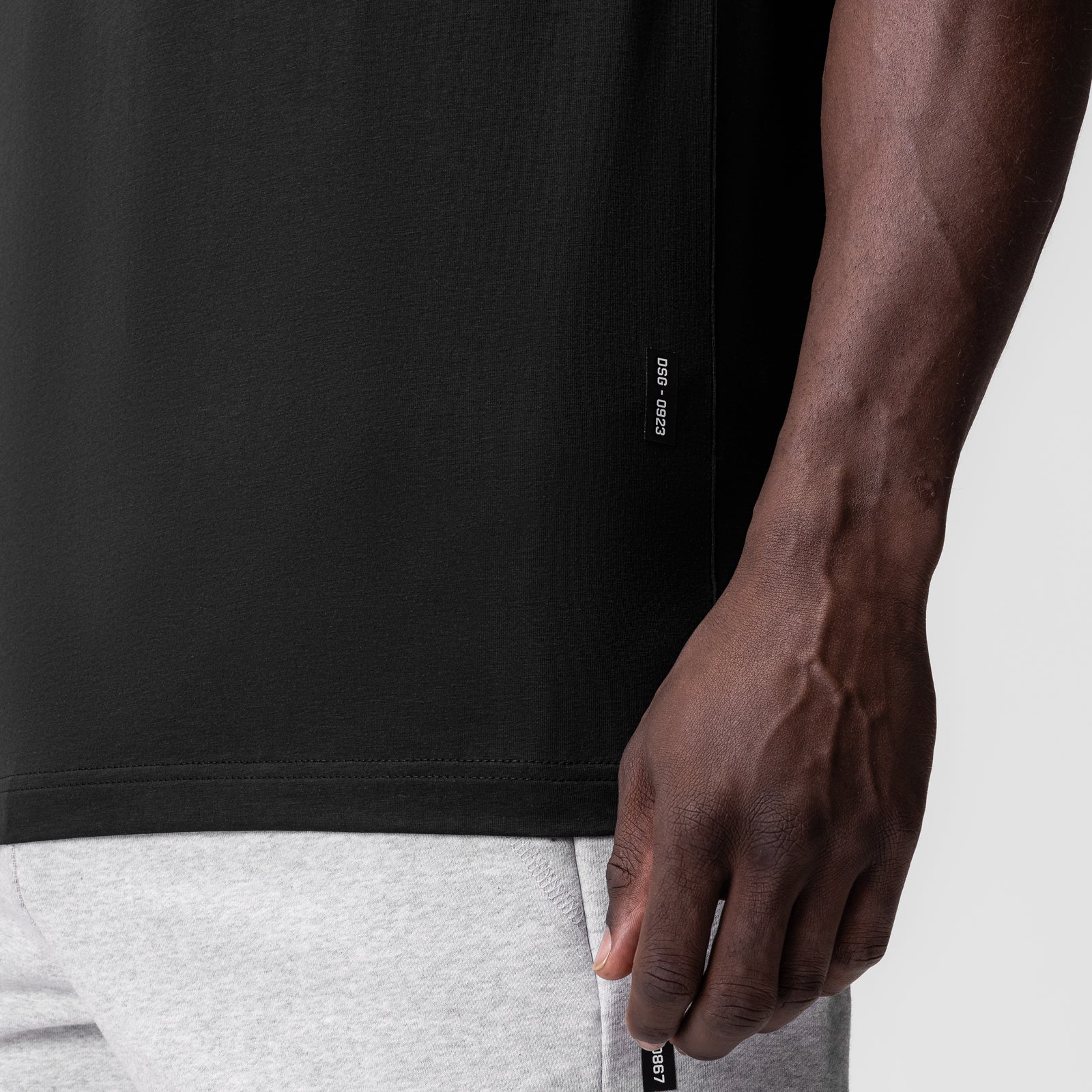 Black Supima Essential Tee worn by model, side detail view showing fit and fabric