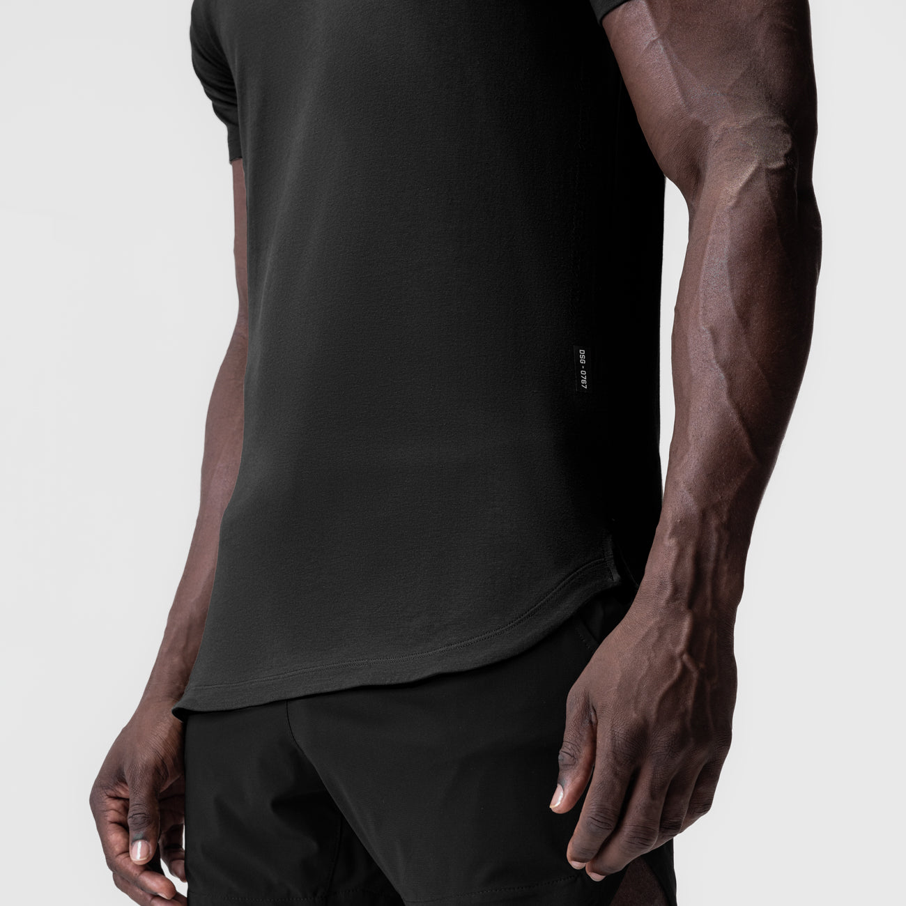 Black Supima Established Tee worn by model, side view showing fit and fabric detail