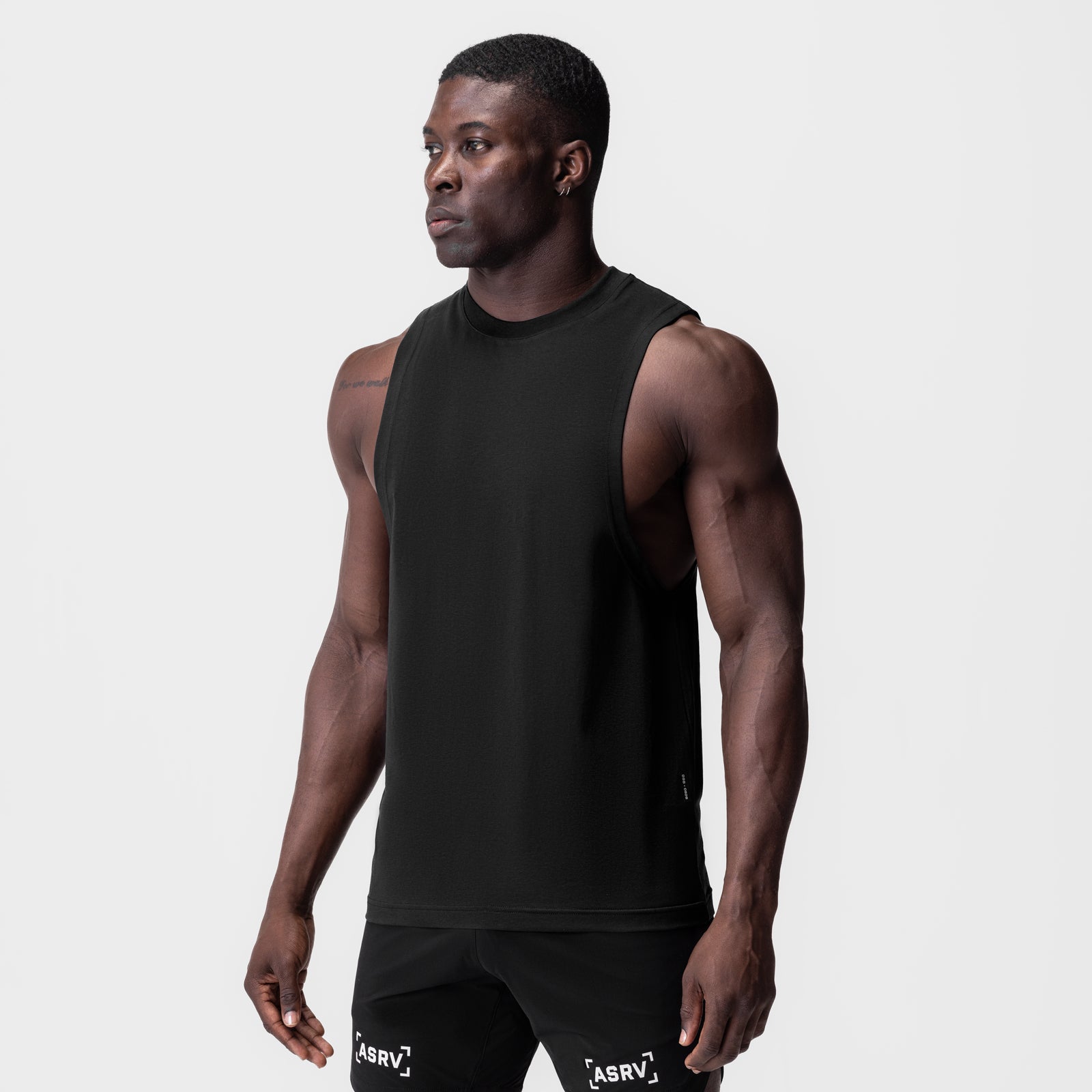 Black Supima® Muscle Tank worn by model, side profile view