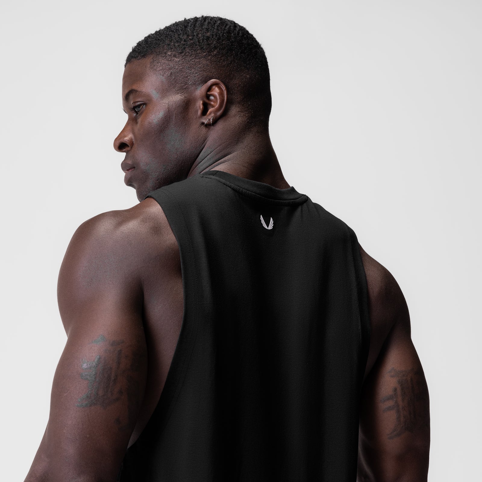 Black Supima® Muscle Tank worn by model, side profile view