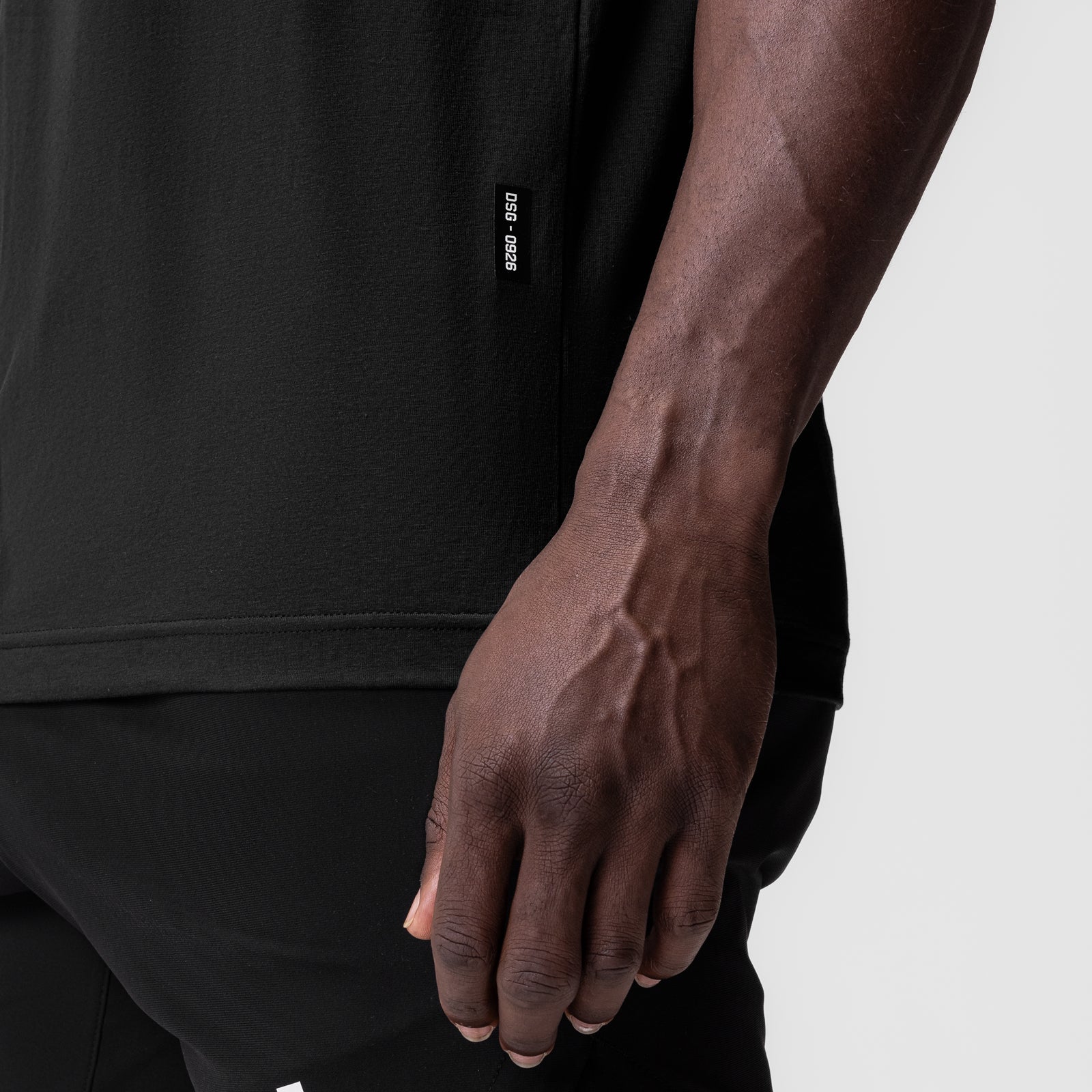 Black Supima Muscle Tank worn by model, side view showing fit and fabric detail