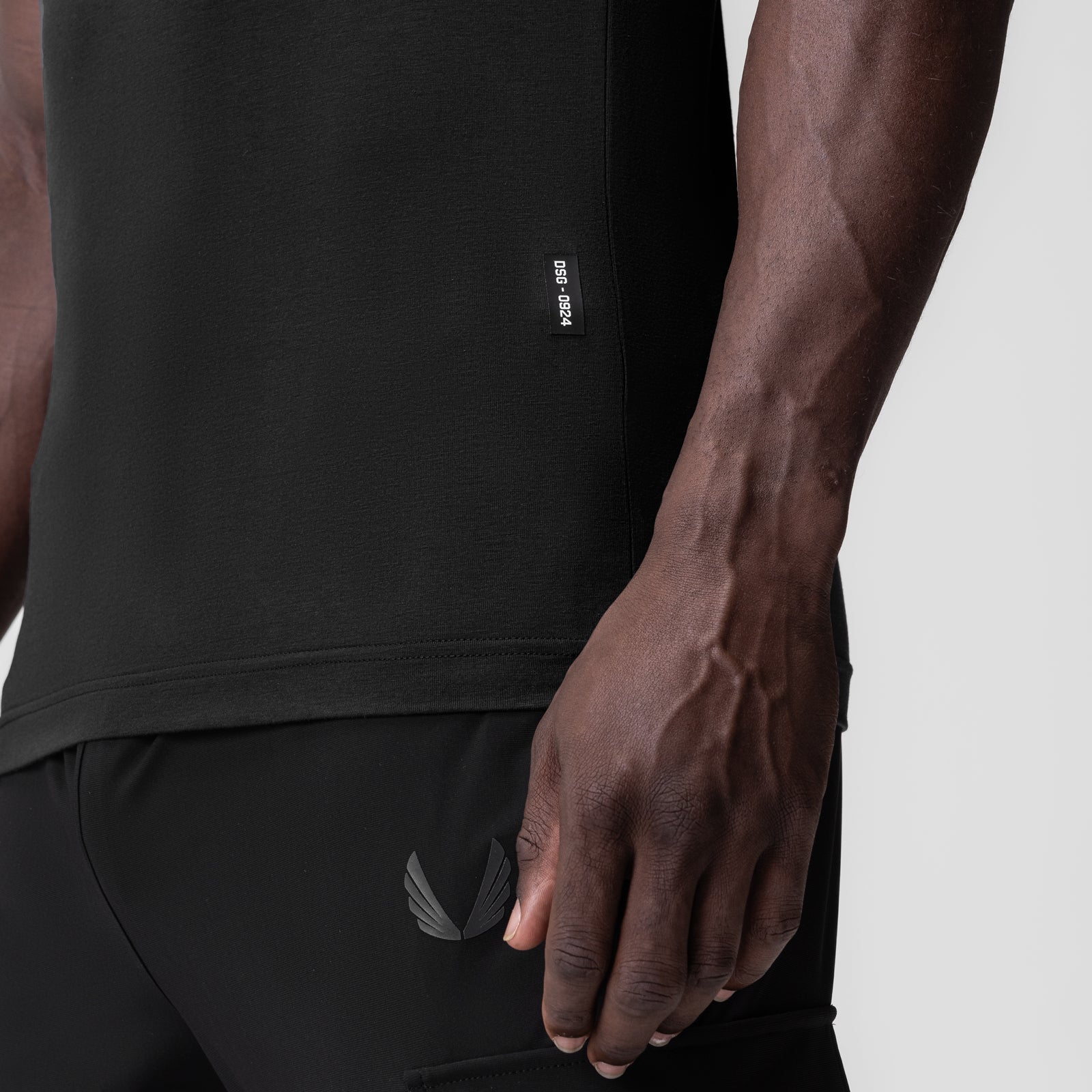 Black Supima Essential Slim Tank worn by model, side view showing fit and fabric detail