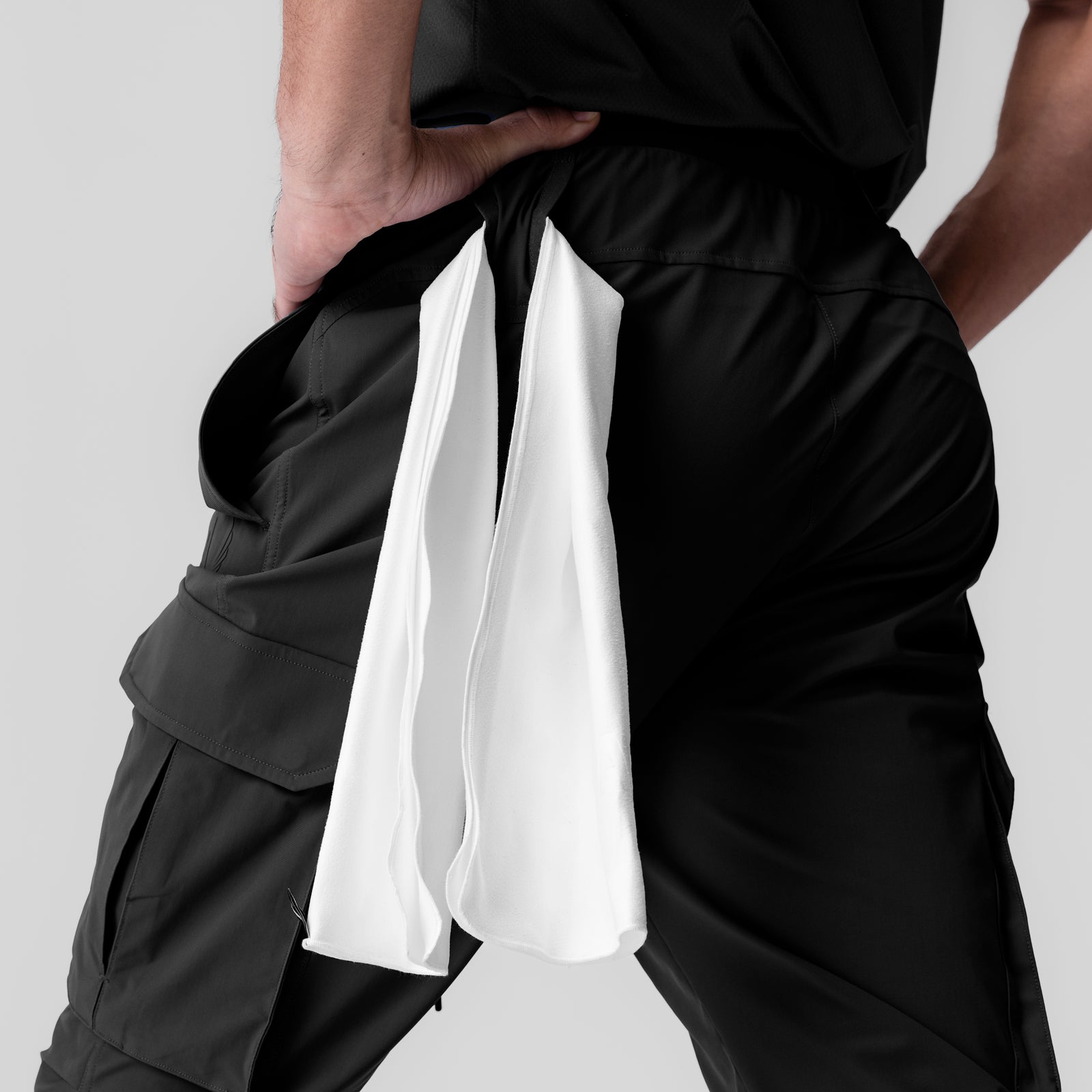 Black Tetra-Lite Ice Cargo High Rib Jogger worn by model, holding white fabric detail