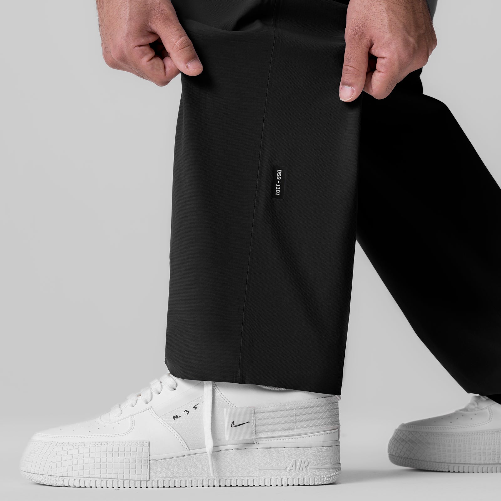 Black Tetra-Lite Field Pant worn with white sneakers, front view detail