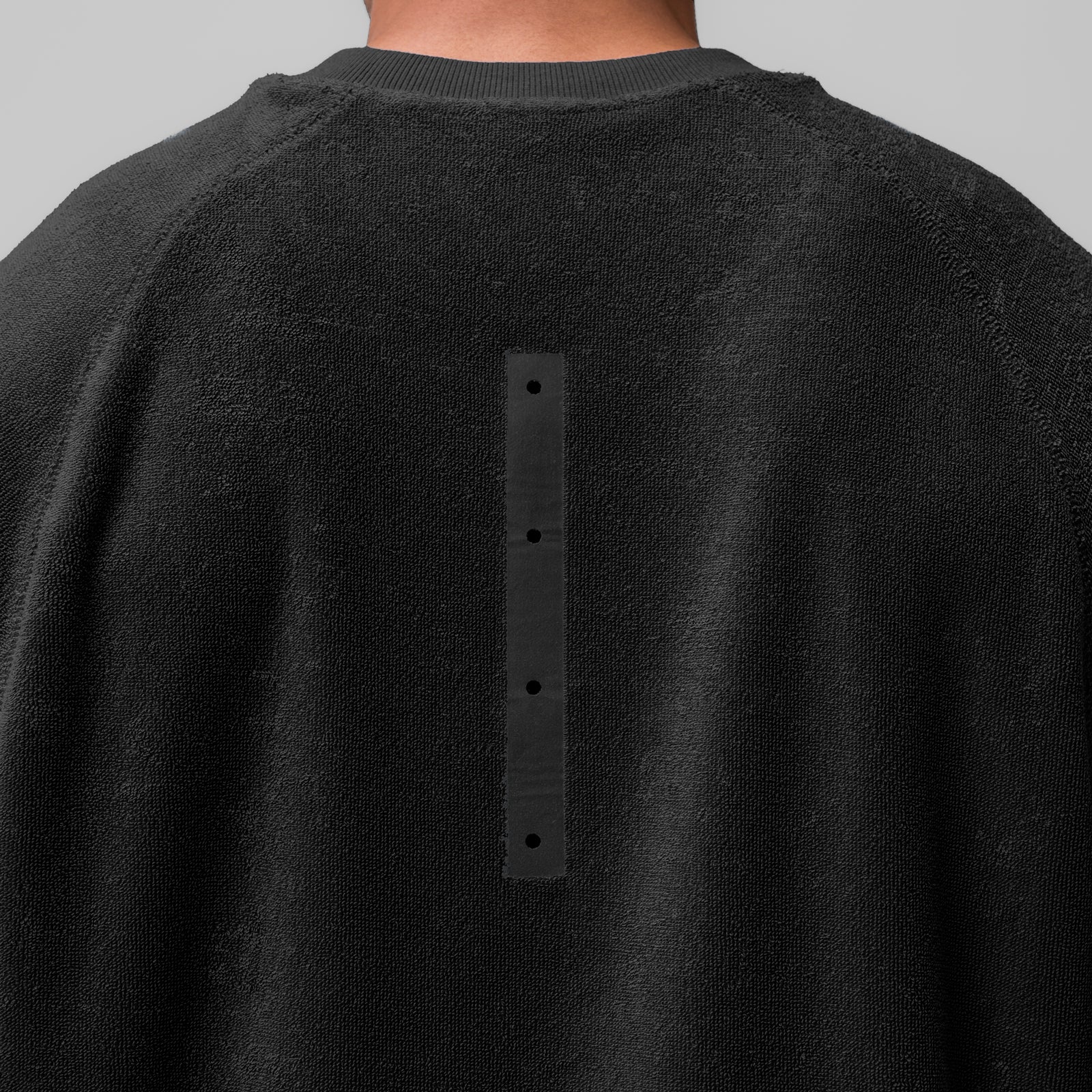 Black Towel Terry Cutoff crewneck worn by model, back view showing button detail